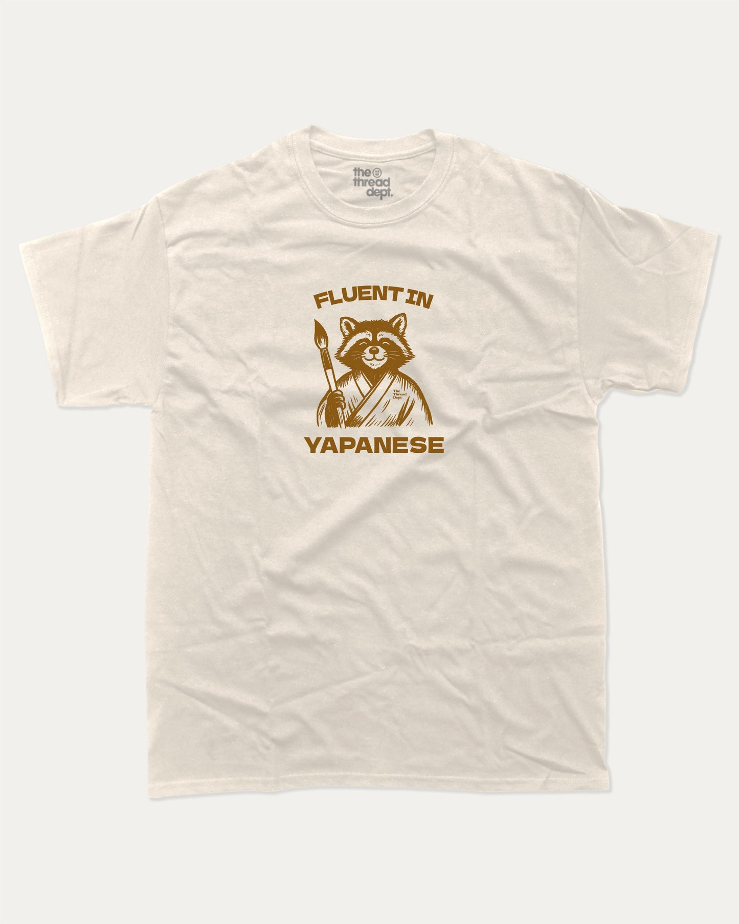 Fluent In Yapanese Racoon graphic t-shirt, perfect funny gift for friends. A must-have animal tee, yapping quotes meme shirt, unique gift idea. Cream.