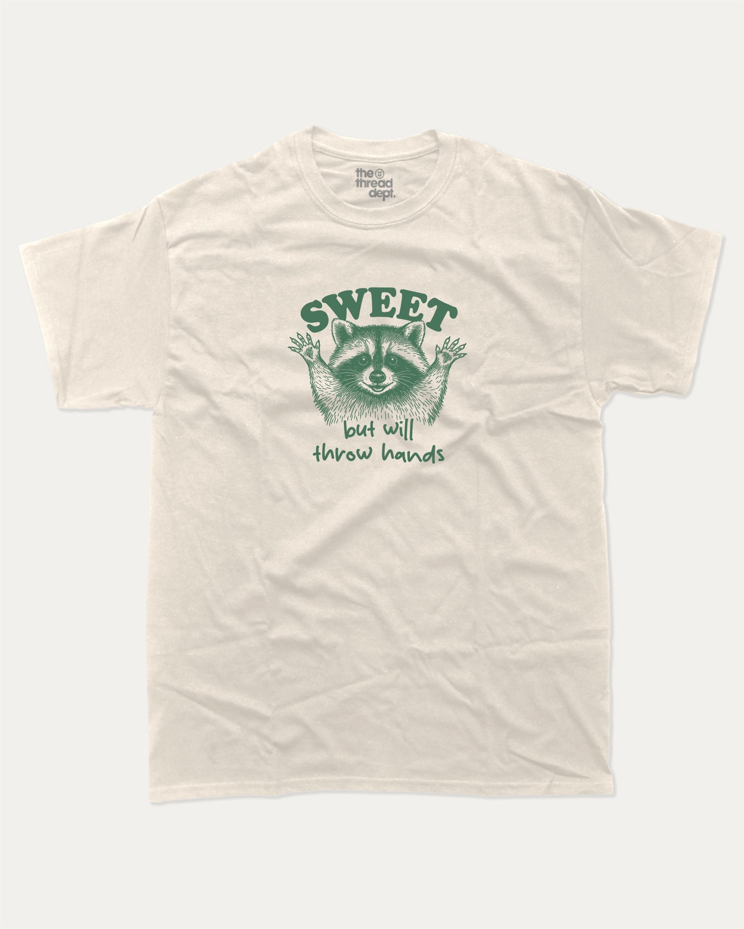 Sweet But Will Throw Hands Raccoon graphic t-shirt, perfect for gifts. Funny raccoon tee, trending meme shirt, unique gift idea. Cream.