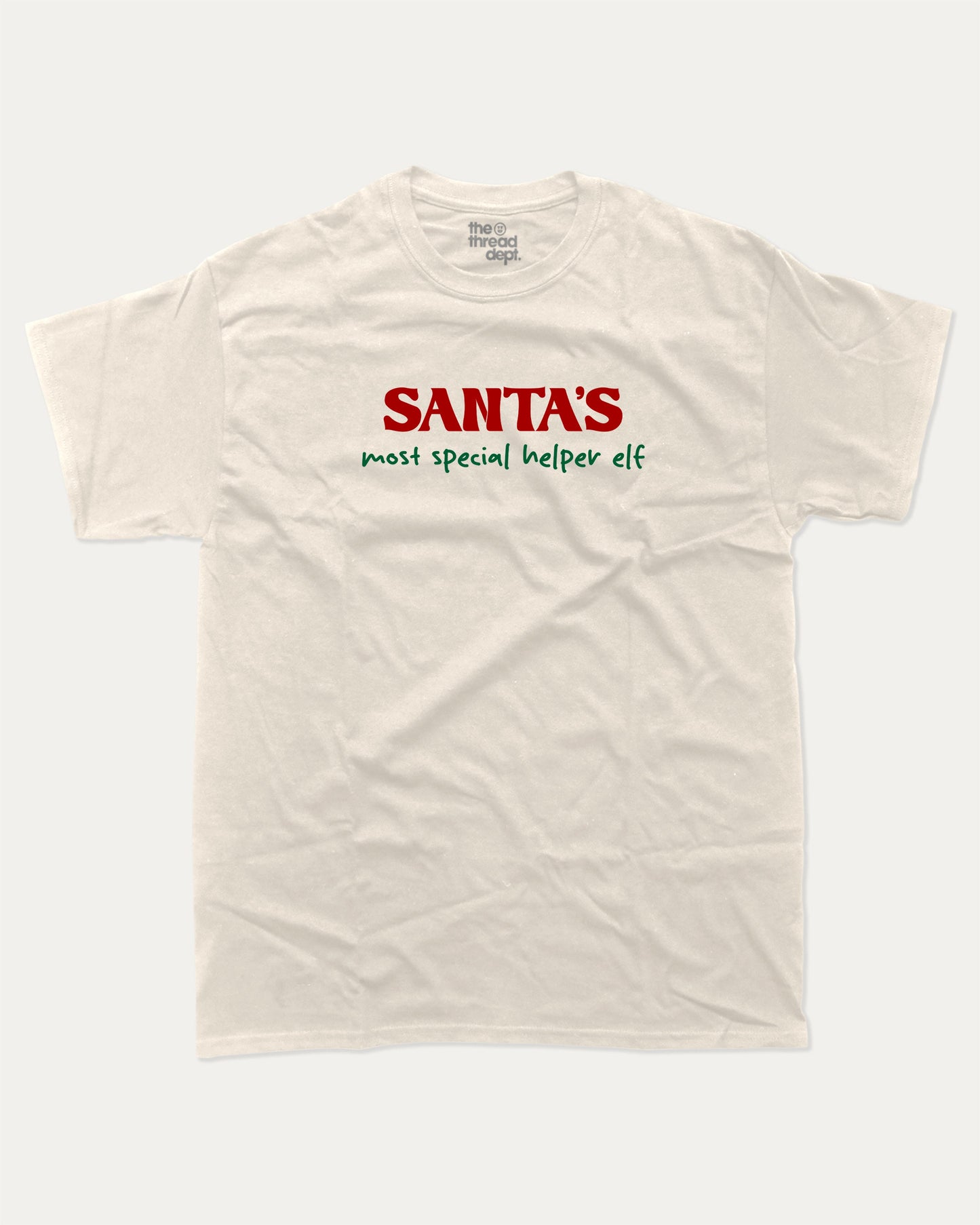 Santa's Most Special Helper graphic tee with bold and humorous print, Perfect Gift for Christmas, Christmas Gift, X-mas Gift for friends, funny and trendy graphic. Perfect for adults and gift-giving. Cream shirt.