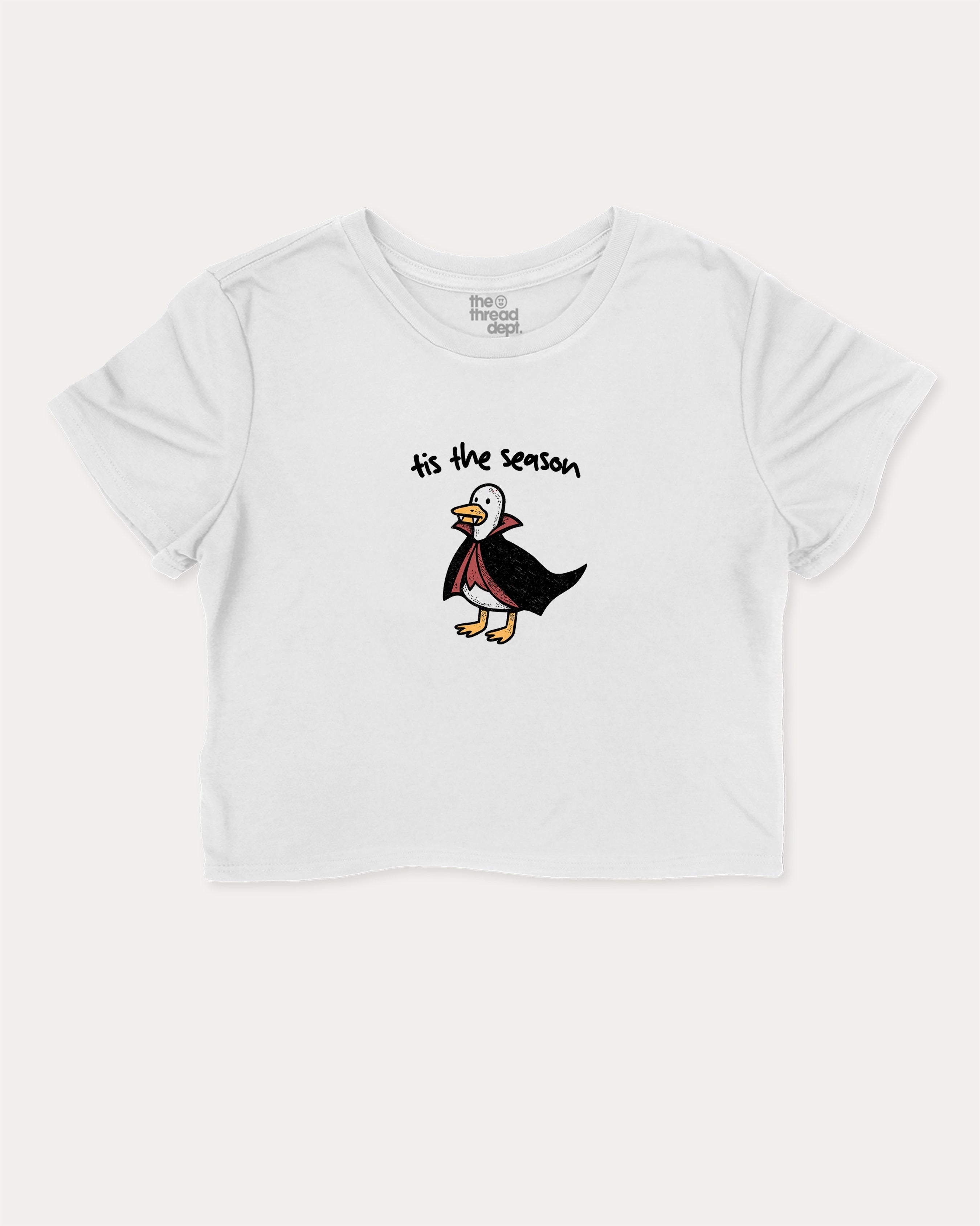 Tis The Season graphic crop tee with funny and trendy slogan print, perfect for women’s casual looks or layering. White crop t-shirt.