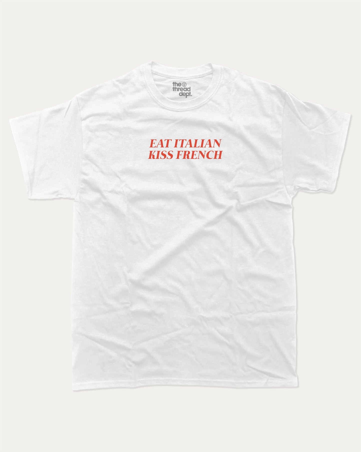 Eat Italian Kiss French graphic tee with bold and humorous print, funny and trendy graphic. Perfect for adults and gift-giving. White shirt.