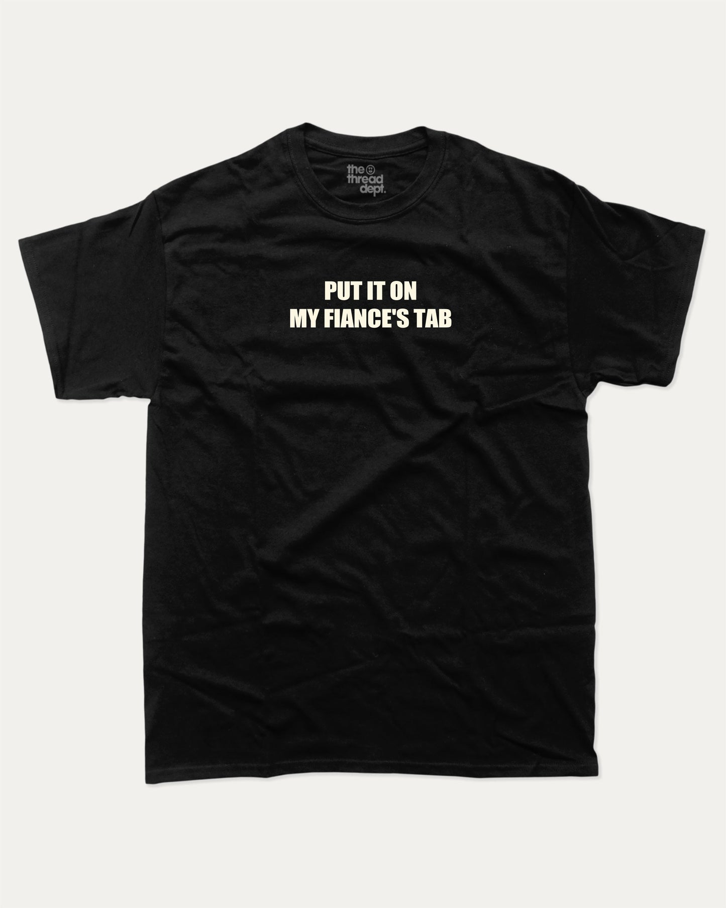Put It On My Fiance's Tab graphic tee with bold and humorous print, funny and trendy graphic. Perfect for adults and gift-giving. Black shirt.