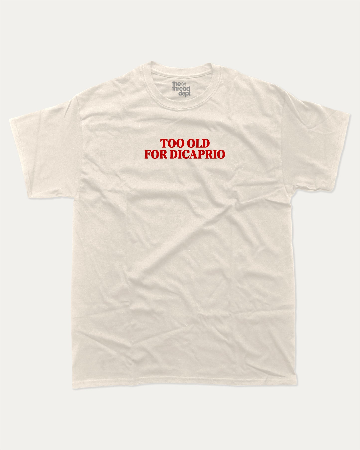 Too Old For Dicaprio graphic tee with bold and humorous print, funny and trendy graphic. Perfect for adults and gift-giving. Cream shirt.