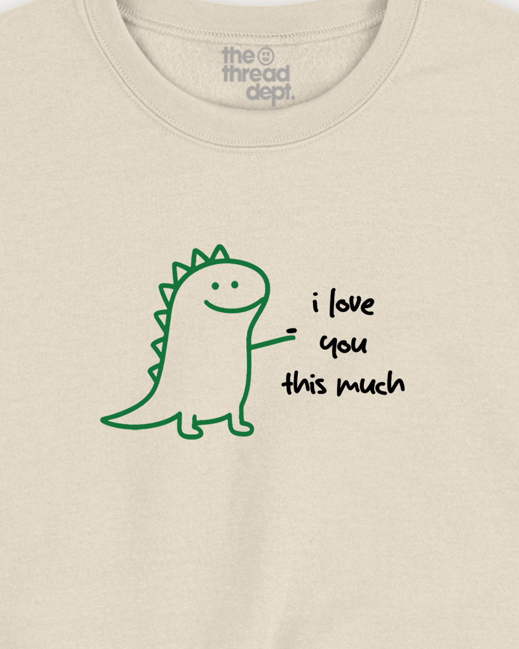Beige t-shirt with a green dinosaur and 'i love you this much' text on a plain background