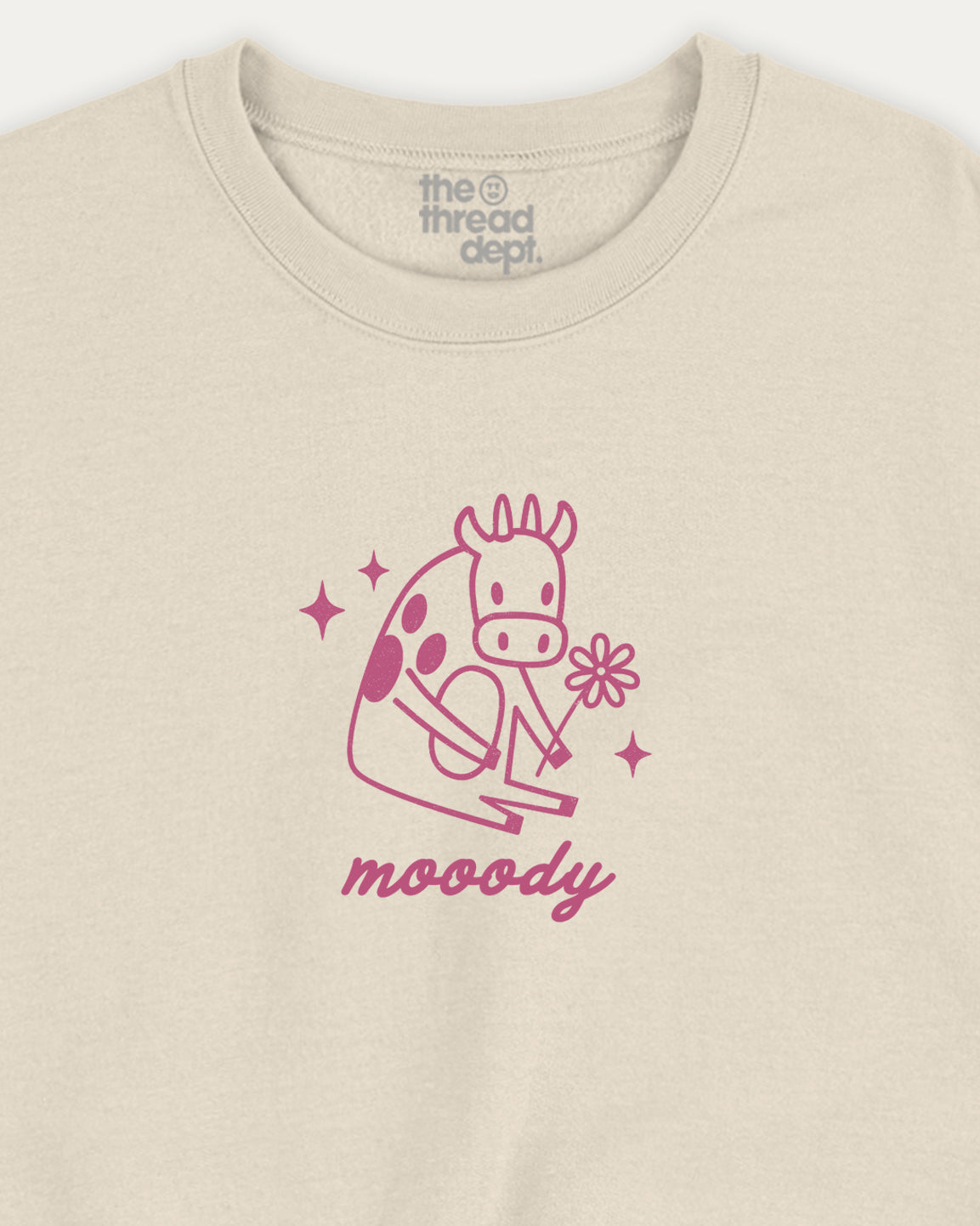 Beige sweatshirt with pink giraffe graphic and 'moody' text on a white background