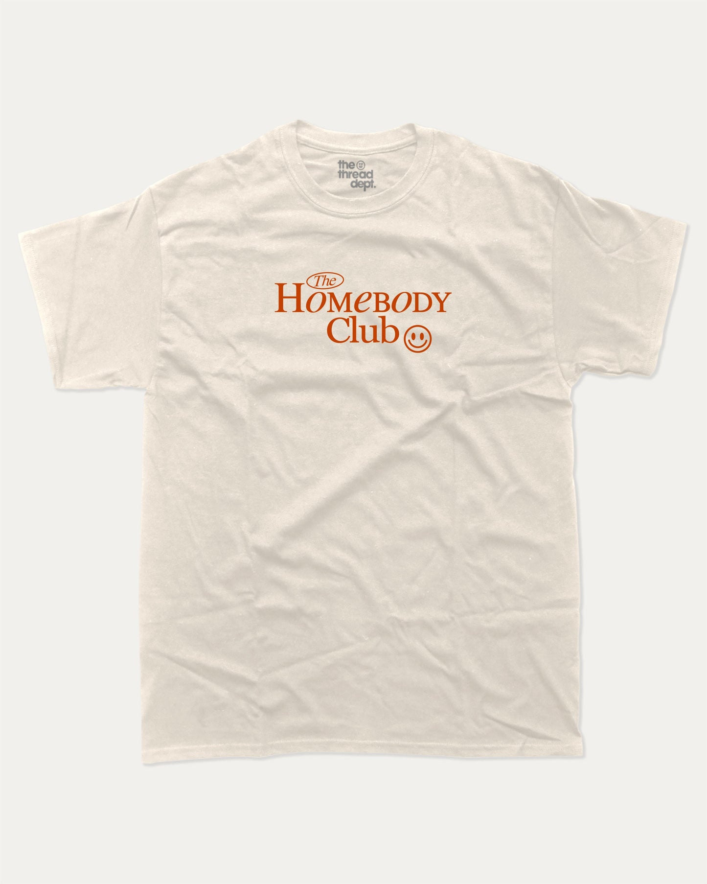 The Homebody Club graphic tee with bold and humorous print, funny and trendy graphic. Vintage Inspired Graphic t shirt, Retro Inspired Graphic T shirt, Perfect for adults and gift-giving. Cream shirt.