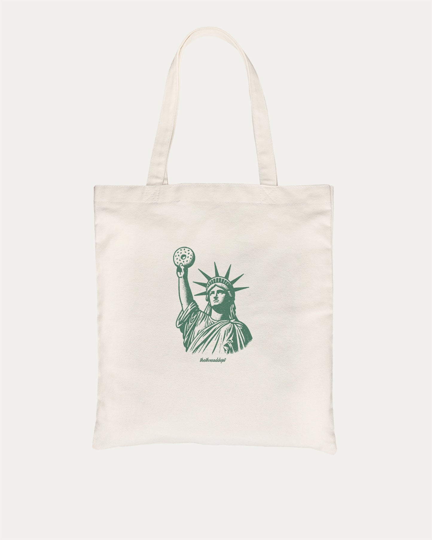 Statue of Liberty Bagle graphic tote bag with bold and funny print, reusable tote for school, errands, or gifting. Natural tote bag.