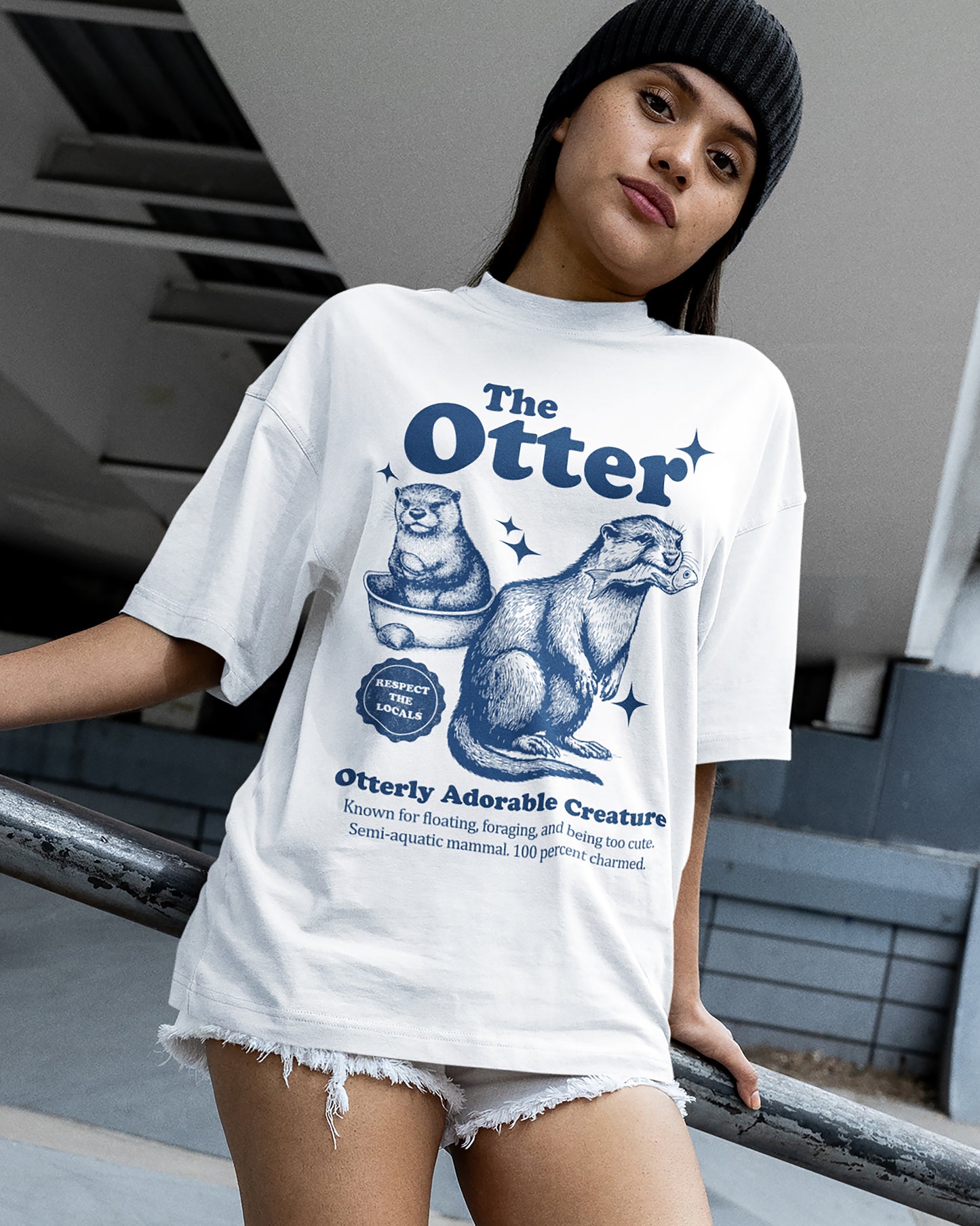 Person wearing a white t-shirt with 'The Otter' graphic design.