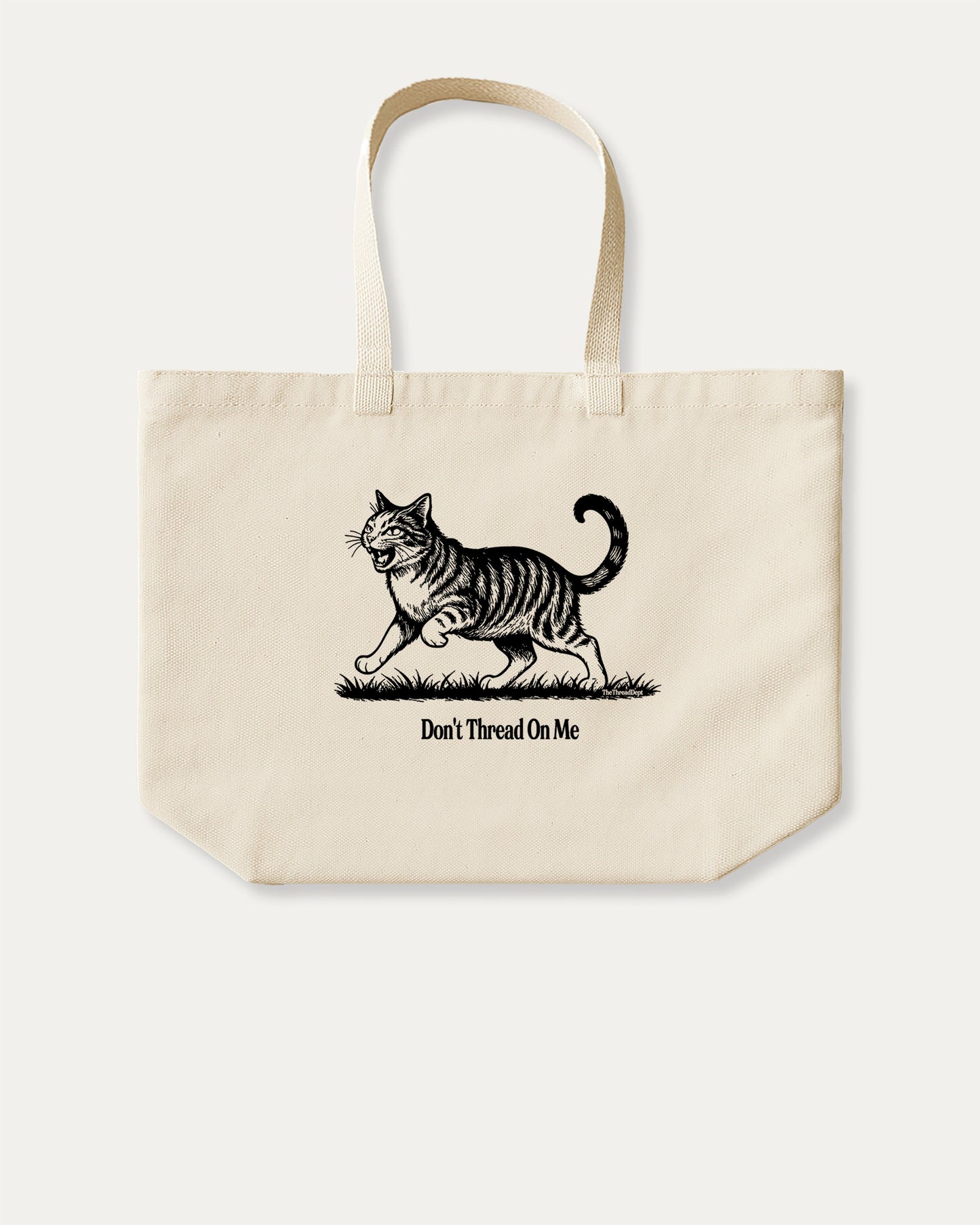 Don't Thread On Me Cat cotton canvas tote bag with humorous graphic, perfect for everyday carry. A must-have aesthetic accessory, great for shopping, school, or casual days. Special gifts for friends. Natural canvas bag