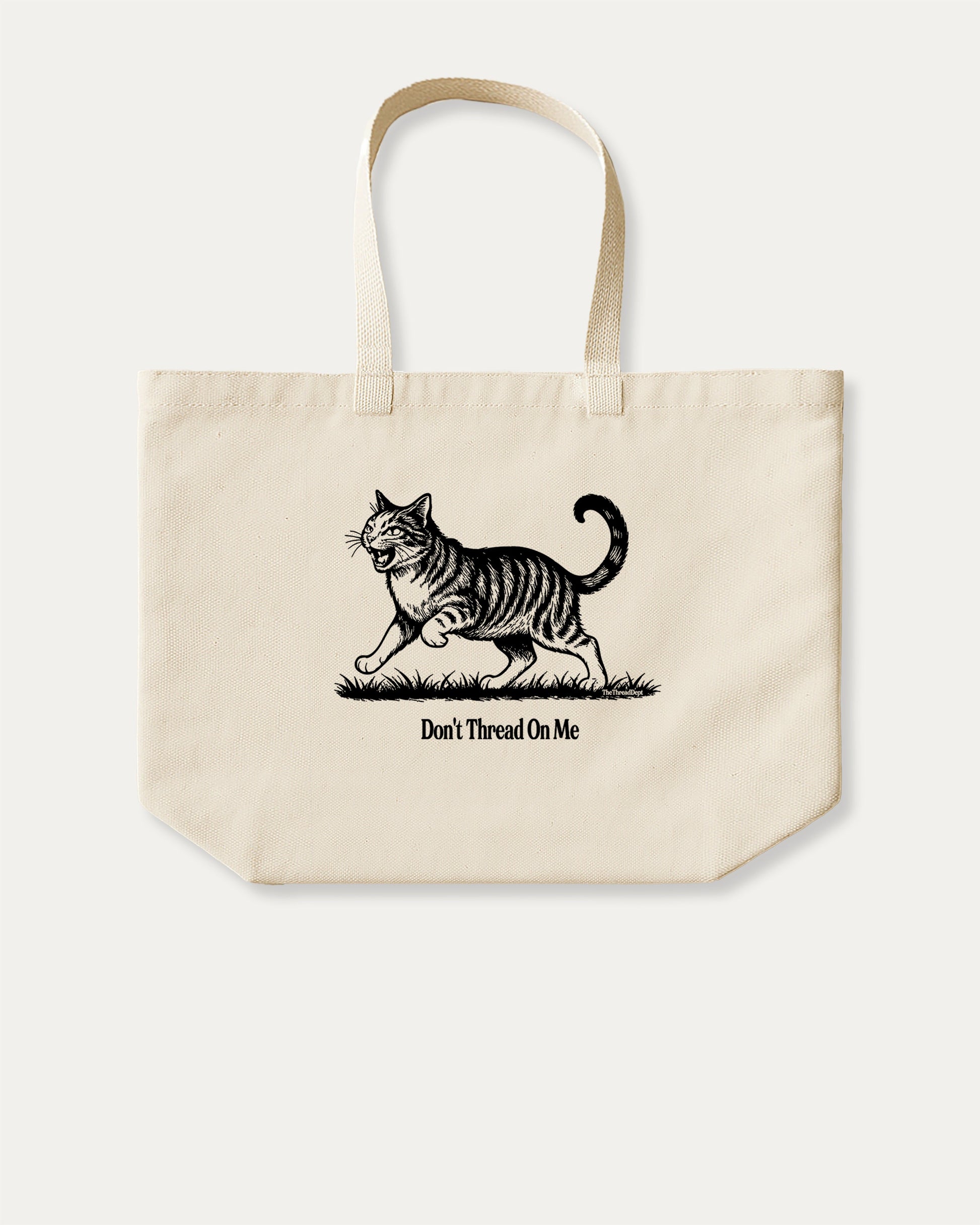 Don't Thread On Me Cat cotton canvas tote bag with humorous graphic, perfect for everyday carry. A must-have aesthetic accessory, great for shopping, school, or casual days. Special gifts for friends. Natural canvas bag