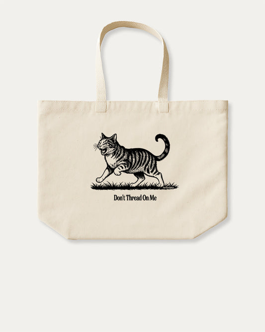 Don't Thread On Me Cat cotton canvas tote bag with humorous graphic, perfect for everyday carry. A must-have aesthetic accessory, great for shopping, school, or casual days. Special gifts for friends. Natural canvas bag