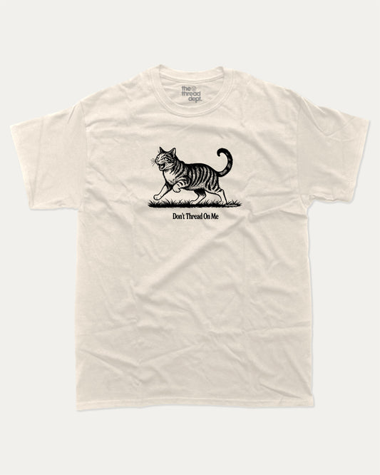 Don't Thread On Me Cat graphic t-shirt, perfect for adults. A must-have funny tee, funny cat shirt, unique gift idea. Cream.