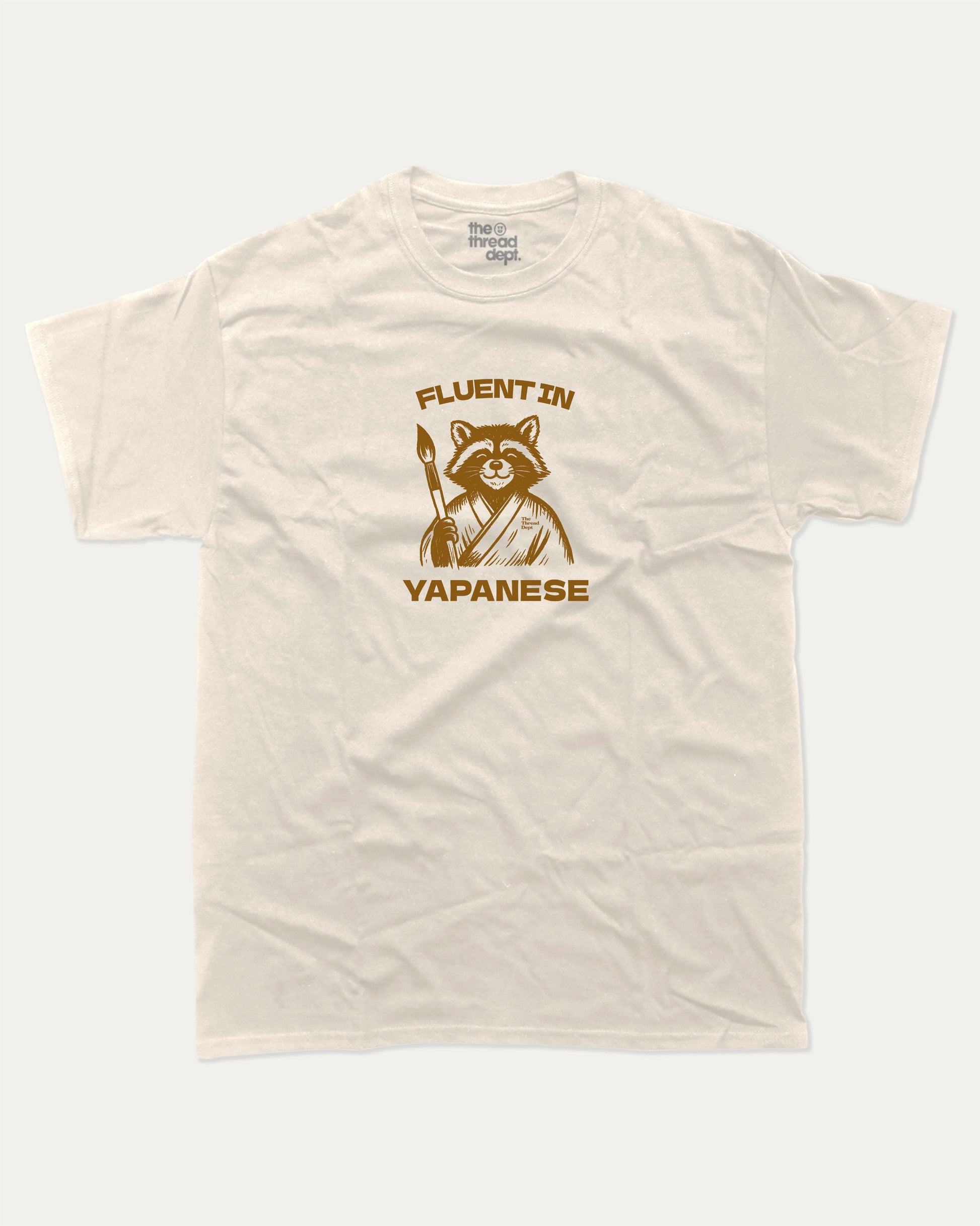 Fluent In Yapanese Racoon graphic t-shirt, perfect funny gift for friends. A must-have animal tee, yapping quotes meme shirt, unique gift idea. Cream.