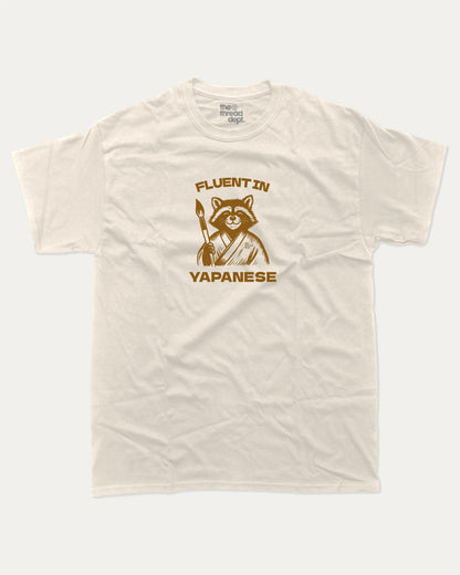 Fluent In Yapanese Racoon graphic t-shirt, perfect funny gift for friends. A must-have animal tee, yapping quotes meme shirt, unique gift idea. Cream.