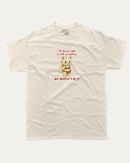 Beige t-shirt with a cartoon cat i became a slut graphic and text on a white background