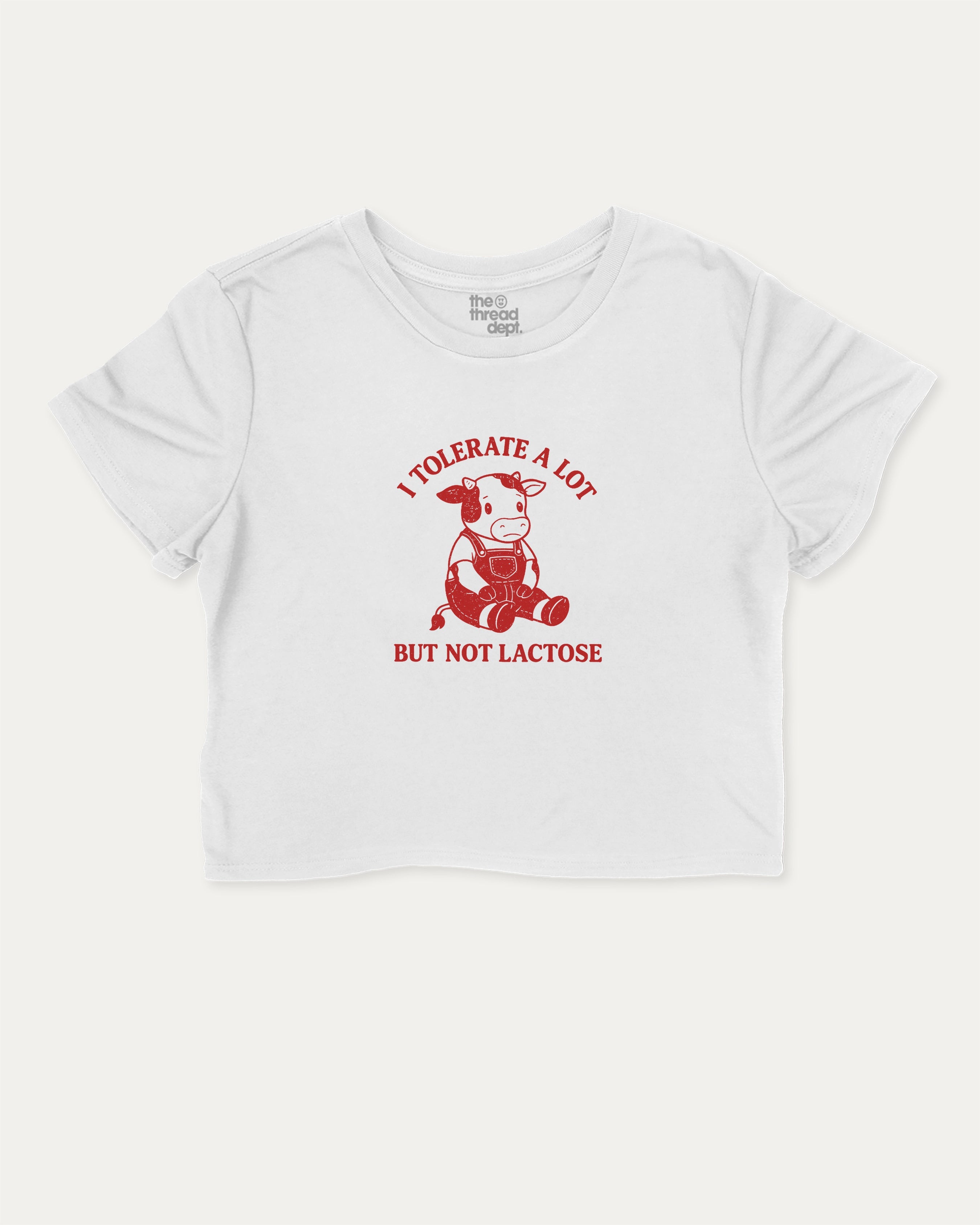 I Tolerate A Lot But Not Lactose cute cow graphic crop tee with funny and trendy slogan print, perfect for women’s casual looks or layering. White crop t-shirt.