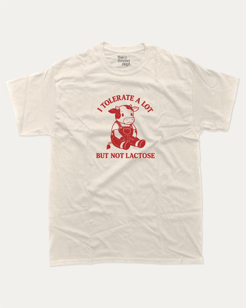 I Tolerate A Lot But Not Lactose graphic tee with cute cow print, funny and trendy graphic. Perfect for adults and gift-giving. Cream shirt.
