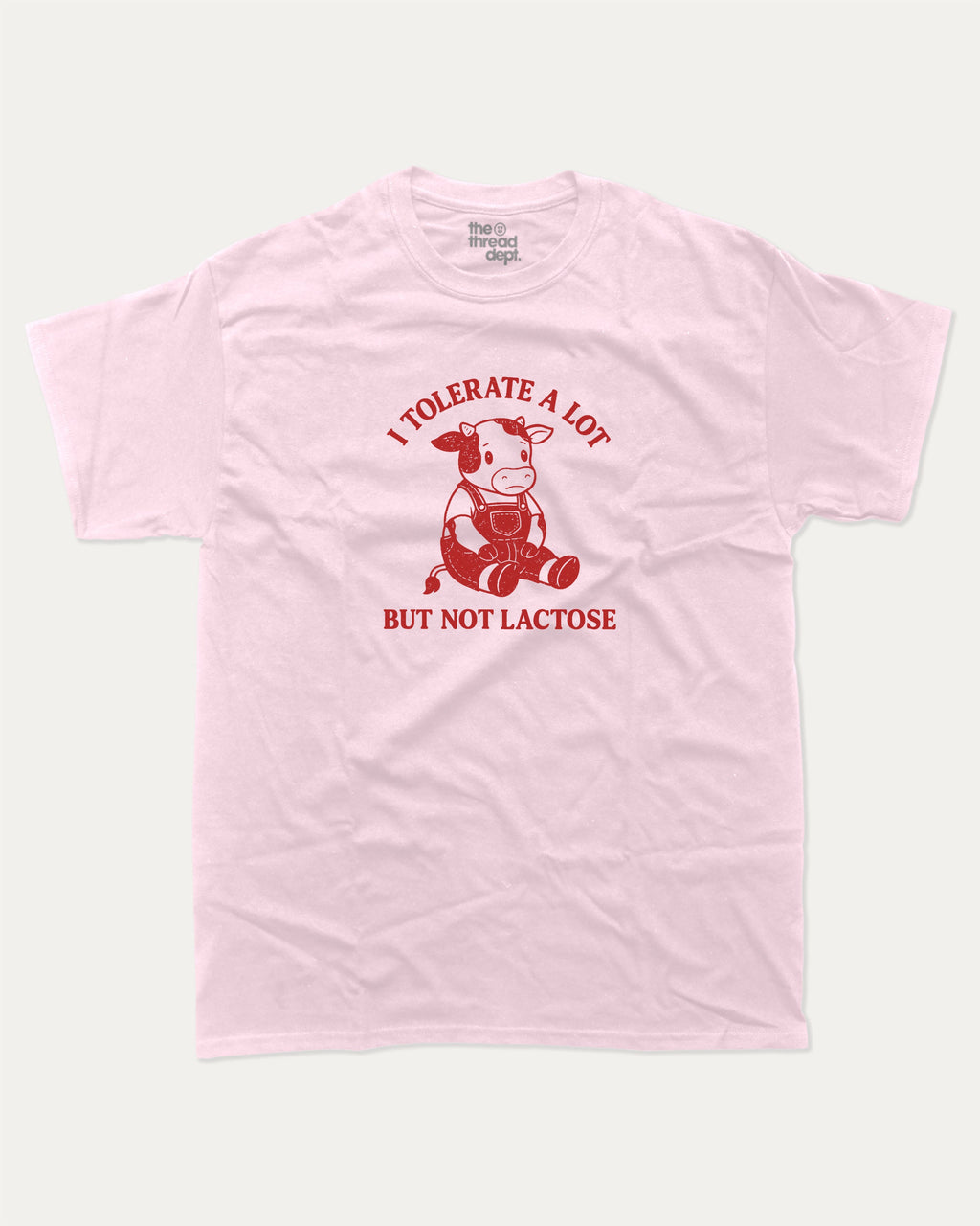 I Tolerate A Lot But Not Lactose graphic tee with cute cow print, funny and trendy graphic. Perfect for adults and gift-giving. Pink shirt.