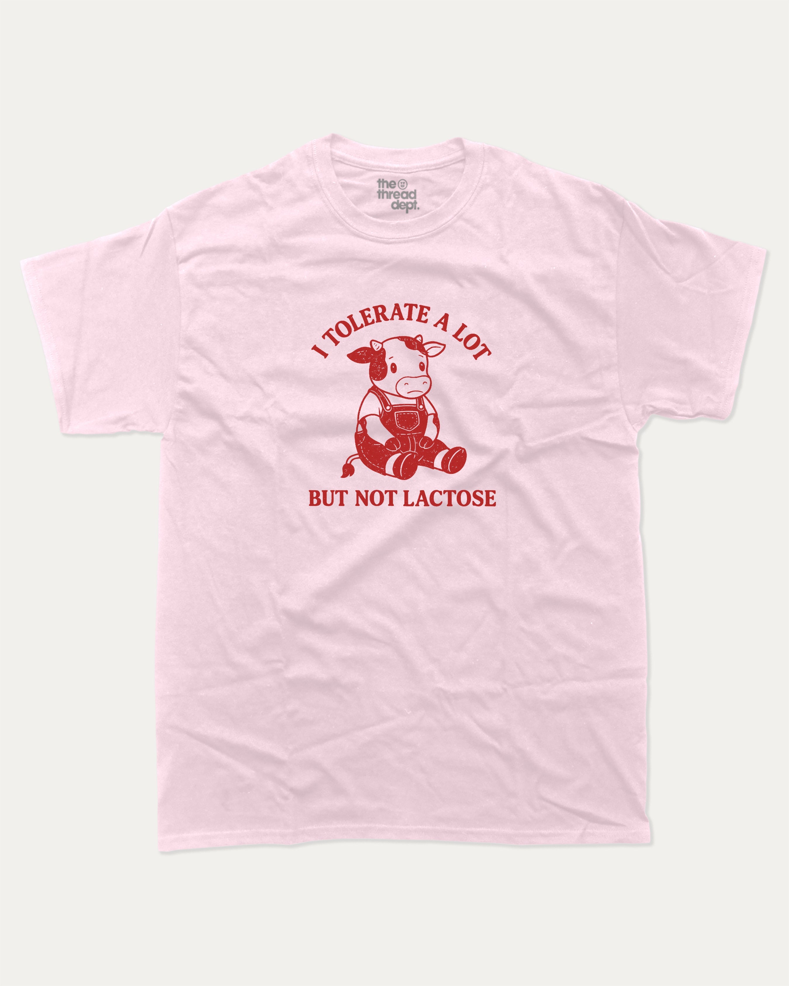 I Tolerate A Lot But Not Lactose graphic tee with cute cow print, funny and trendy graphic. Perfect for adults and gift-giving. Pink shirt.