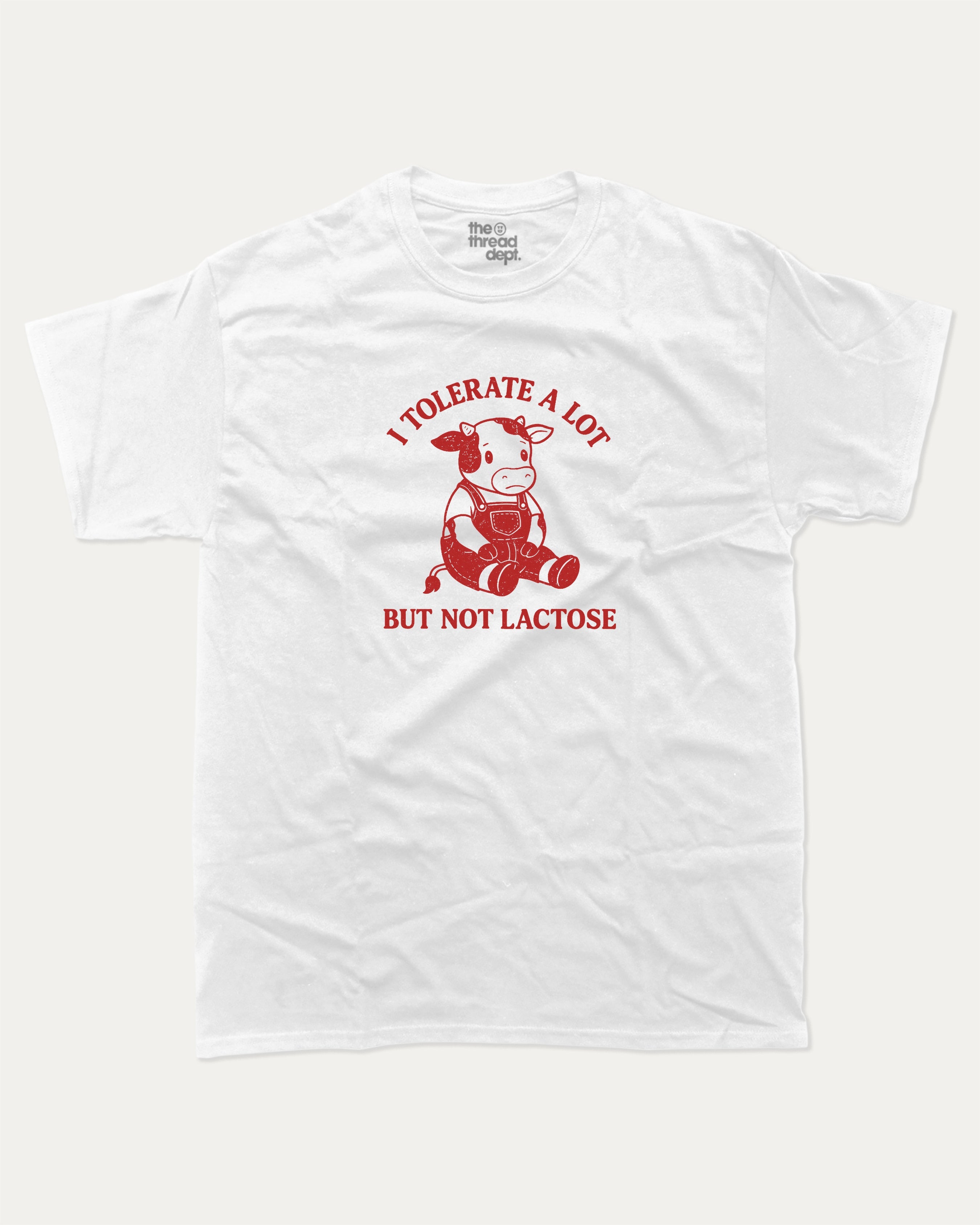 I Tolerate A Lot But Not Lactose graphic tee with cute cow print, funny and trendy graphic. Perfect for adults and gift-giving. White shirt.