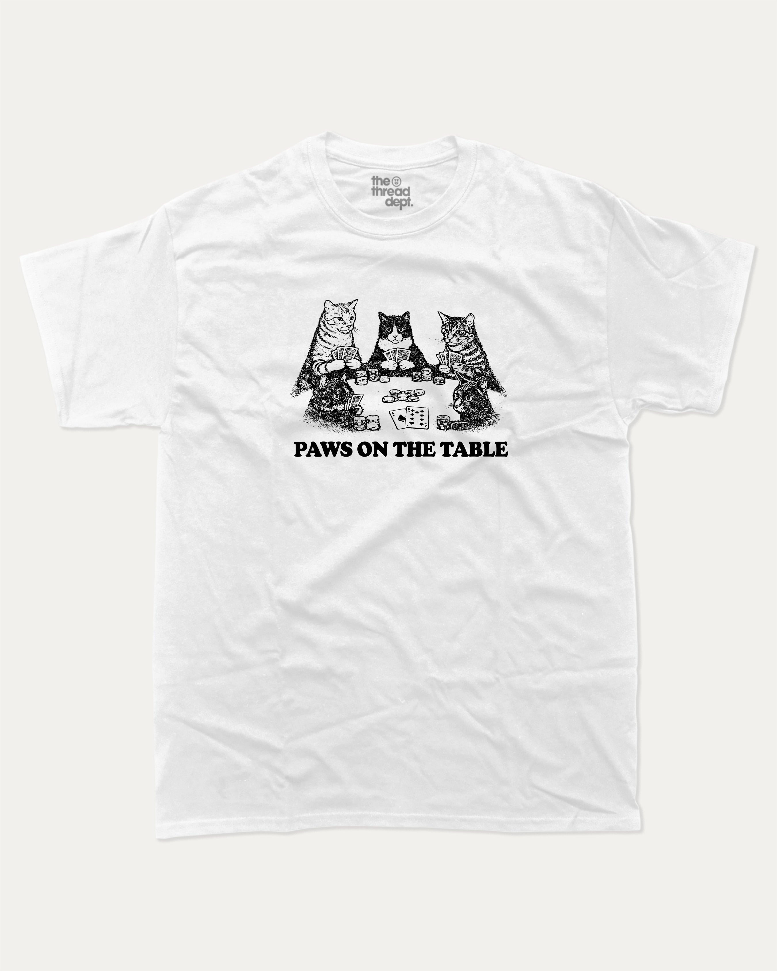 Paws On the Table graphic tee with bold and humorous print, funny and trendy graphic. Perfect for adults and gift-giving. White shirt.