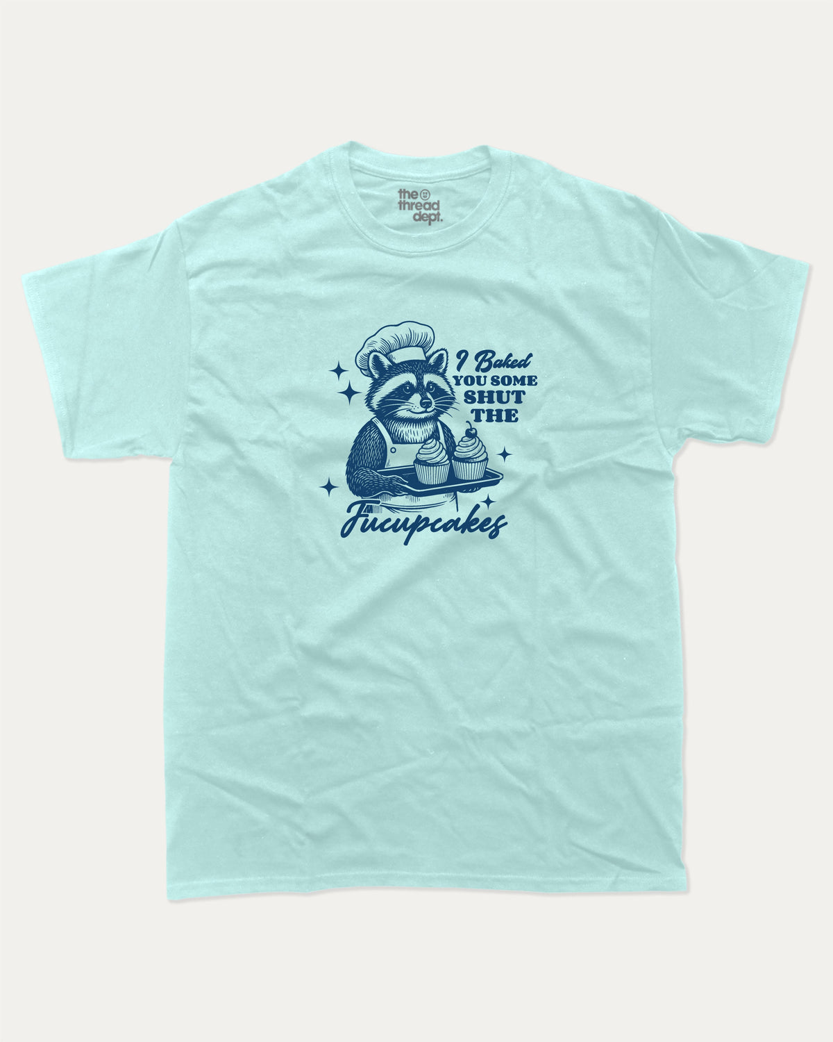 Shut The Fucupcakes Racoon graphic t-shirt, Funny Animal Graphic T shirt, Humorous Animal T shirt, Cute Animal Graphic T shirt, A must-have funny tee, trending meme shirt, unique gift idea. Celadon.