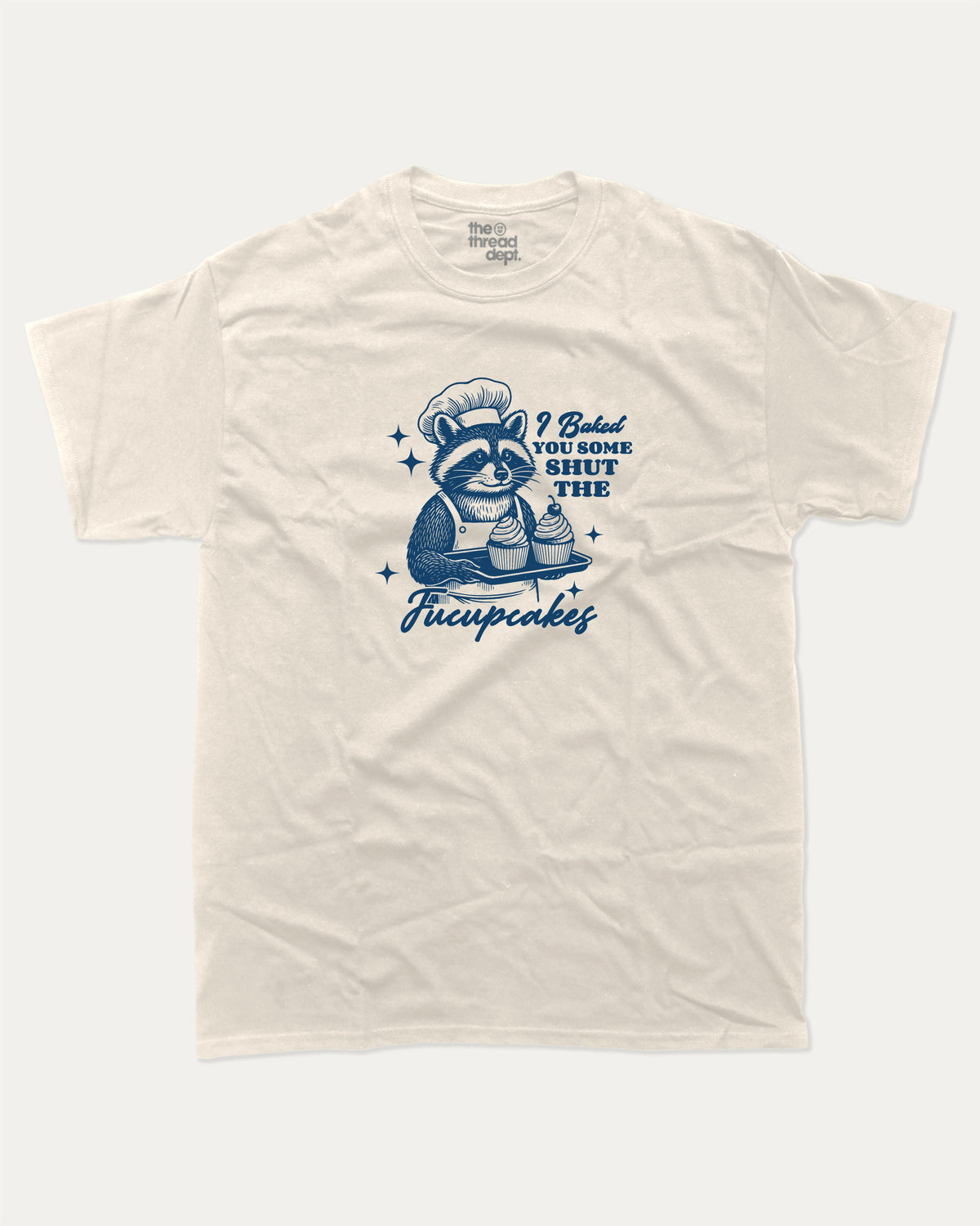 Shut The Fucupcakes Racoon graphic t-shirt, Funny Animal Graphic T shirt, Humorous Animal T shirt, Cute Animal Graphic T shirt, A must-have funny tee, trending meme shirt, unique gift idea. Cream.