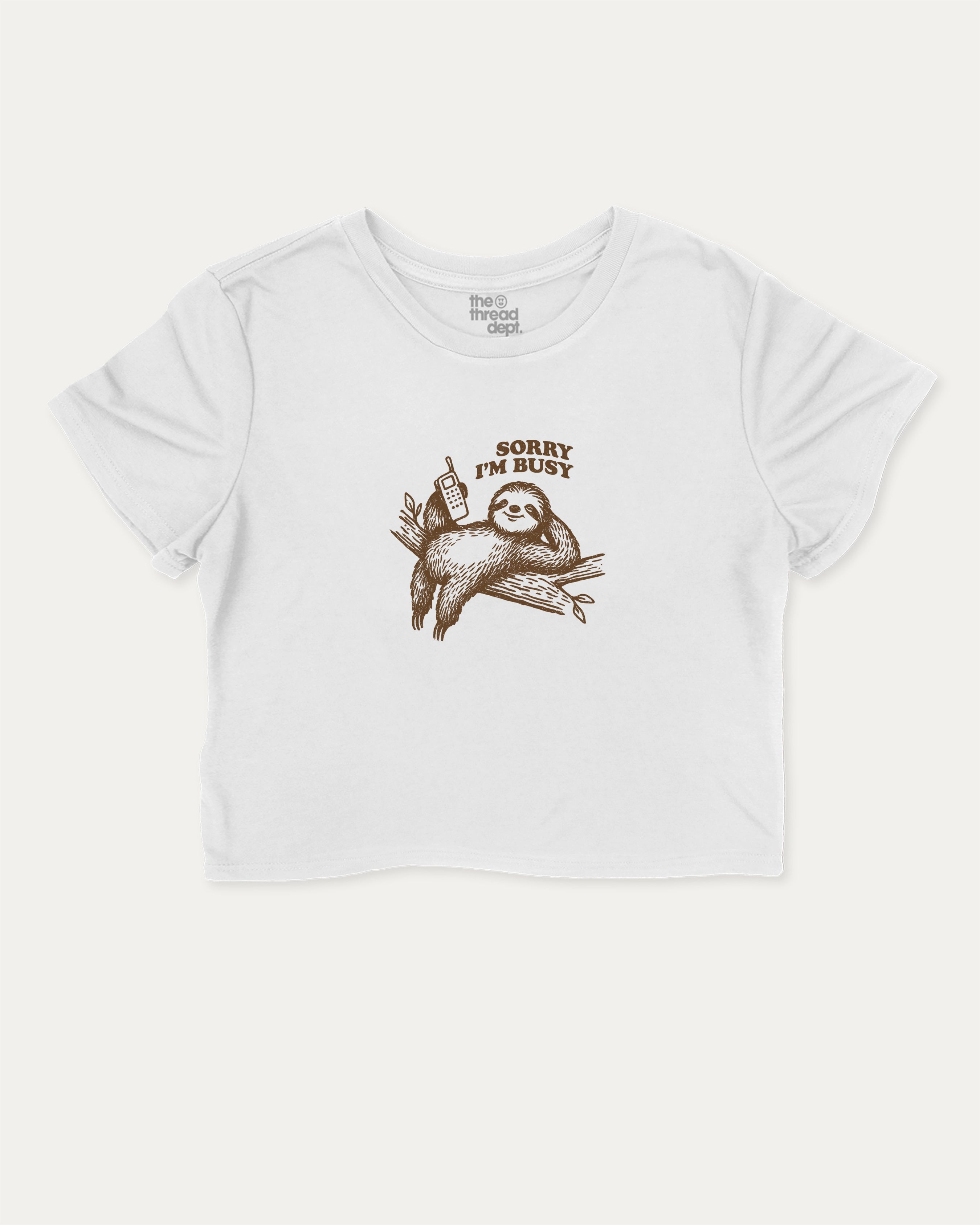 Sorry I'm Busy graphic crop tee with funny sloth print, perfect for women’s casual looks or layering. White crop t-shirt.