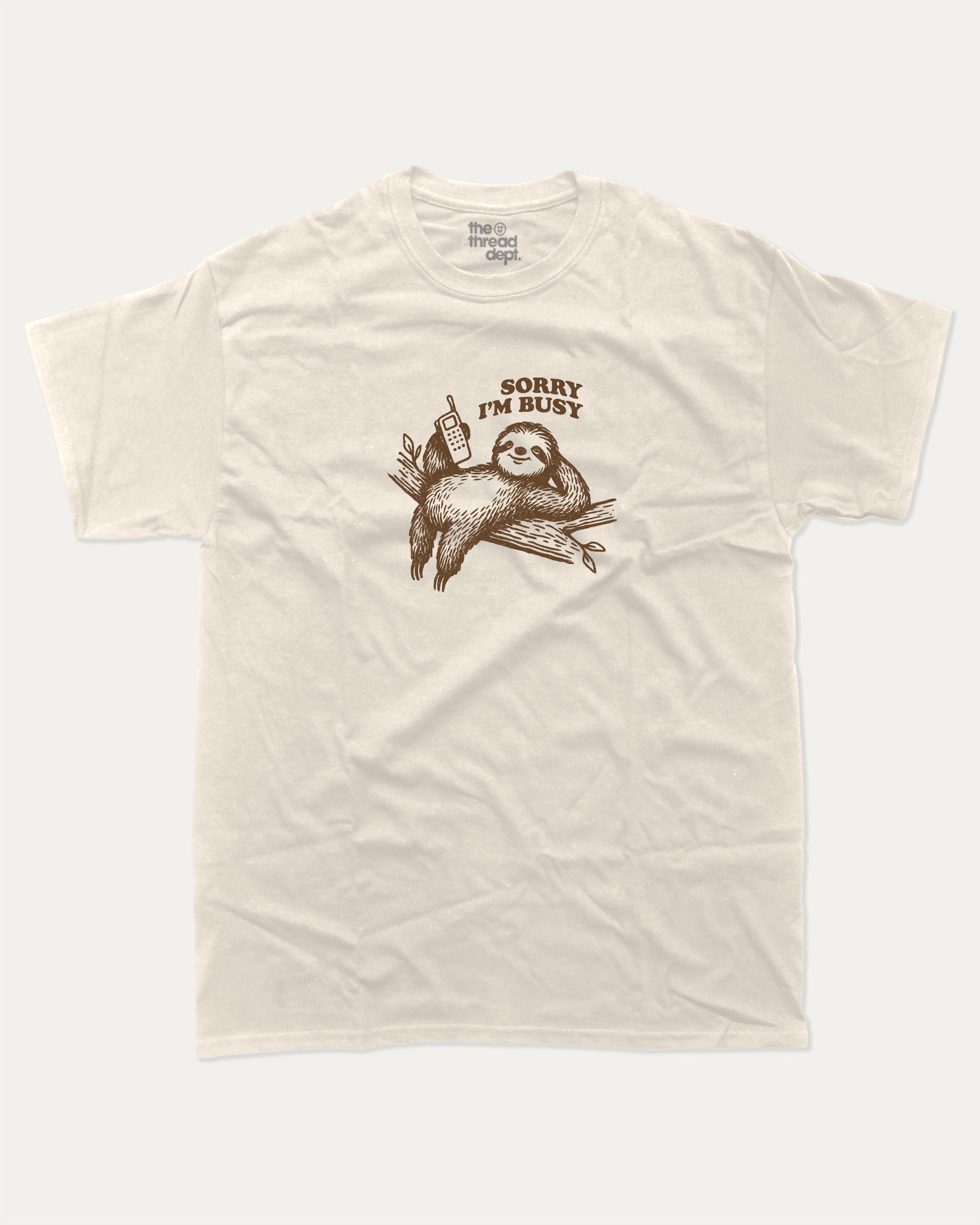 Sorry I'm Busy graphic tee with funny sloth print, funny and trendy graphic. Perfect for adults and gift-giving. Cream shirt.
