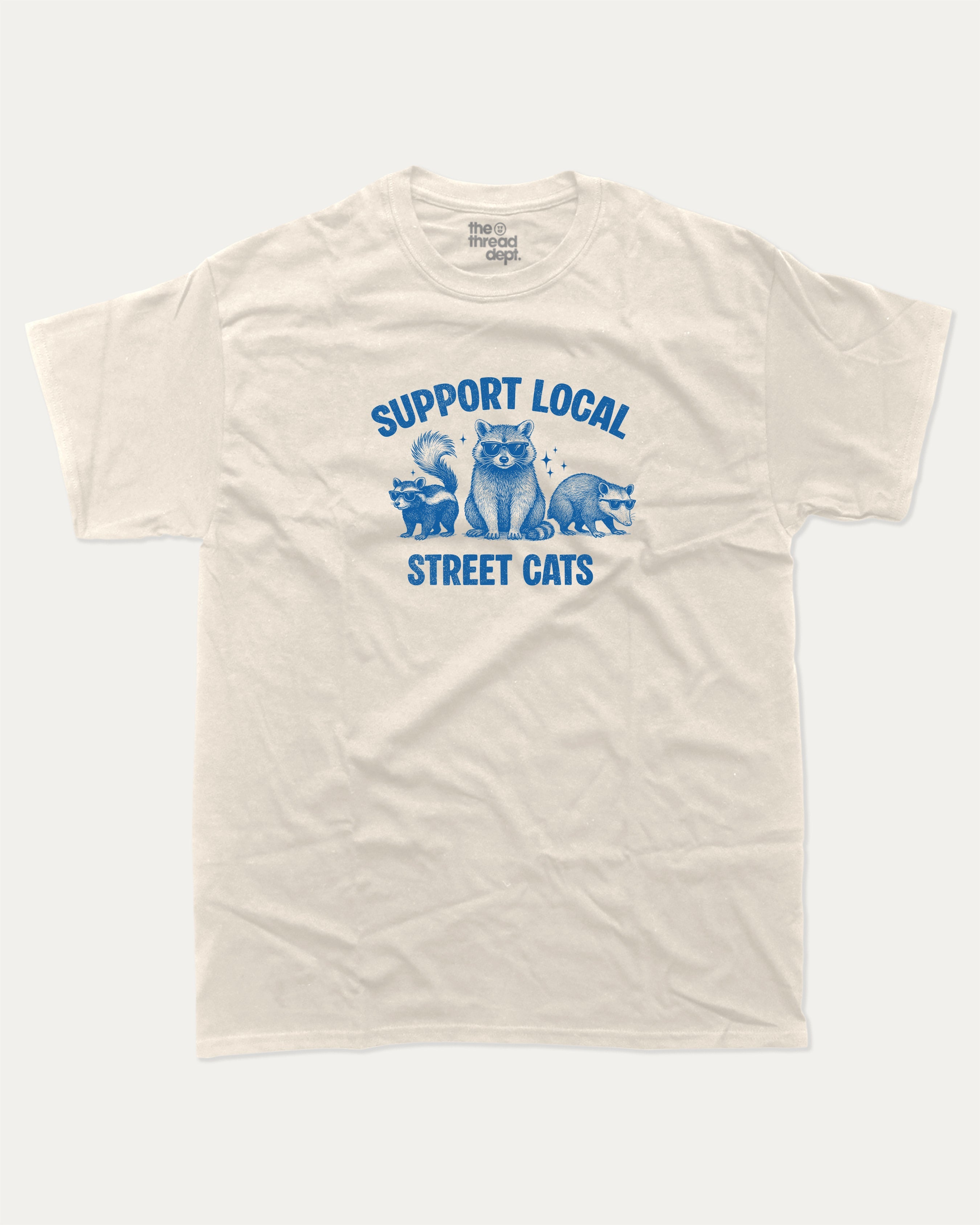 Support Local Street Cats graphic tee with bold and humorous print, Perfect Gift for Cat Lover, Cat Person Graphic T shirt,  funny and trendy graphic. Perfect for adults and gift-giving. Cream shirt.