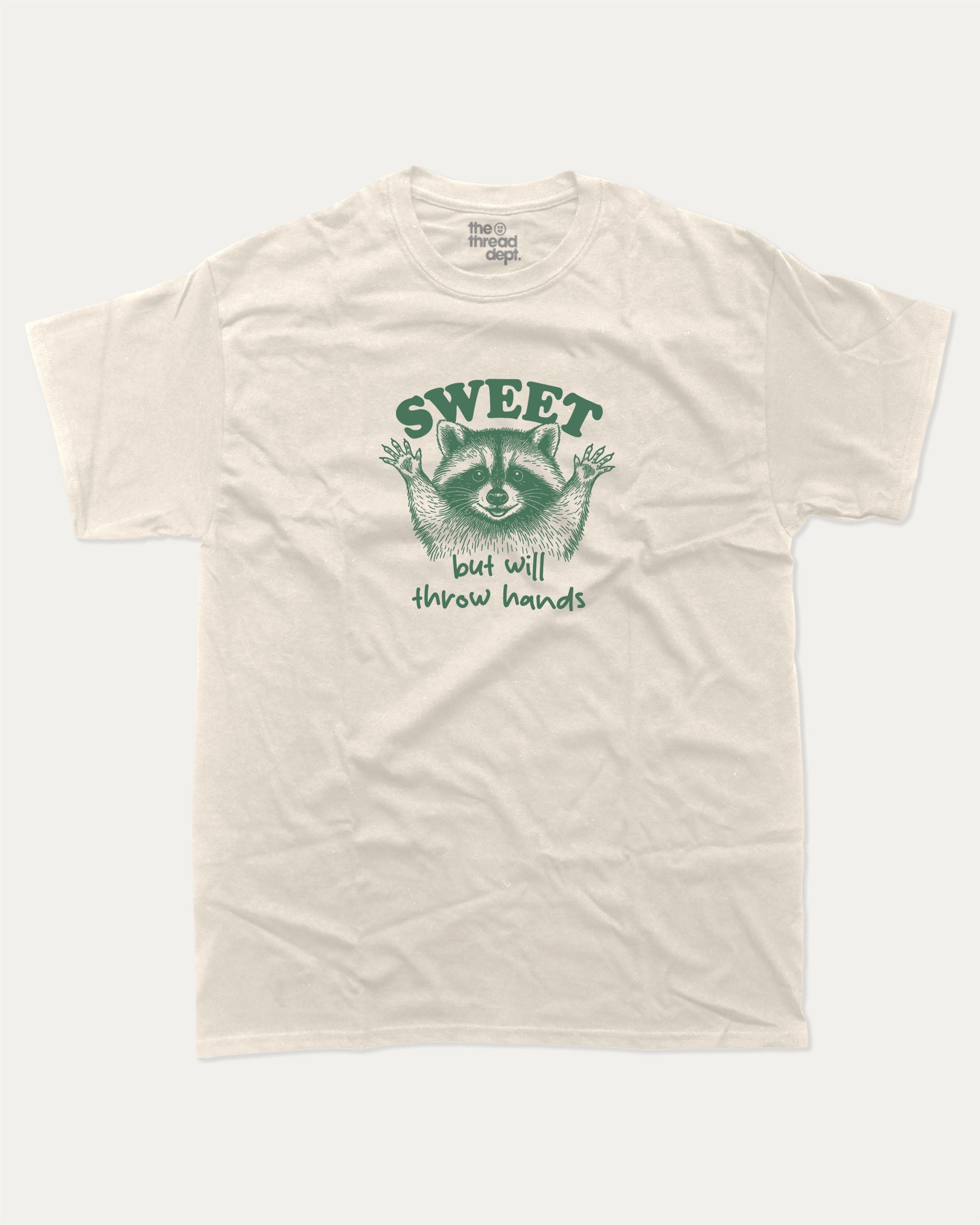 Sweet But Will Throw Hands Raccoon graphic t-shirt, perfect for gifts. Funny raccoon tee, trending meme shirt, unique gift idea. Cream.