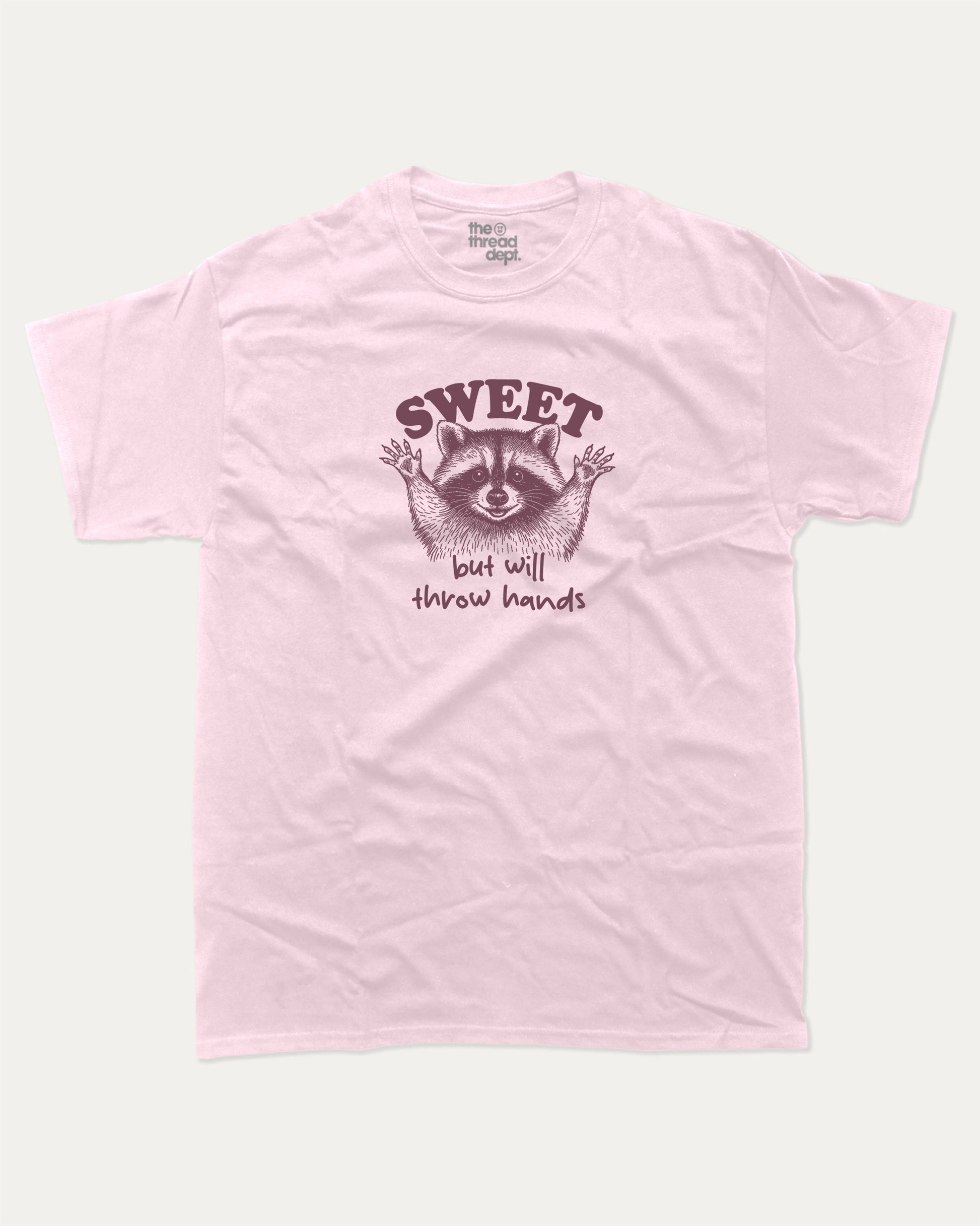 Sweet But Will Throw Hands Raccoon graphic t-shirt, perfect for gifts. Funny raccoon tee, trending meme shirt, unique gift idea. Pink.