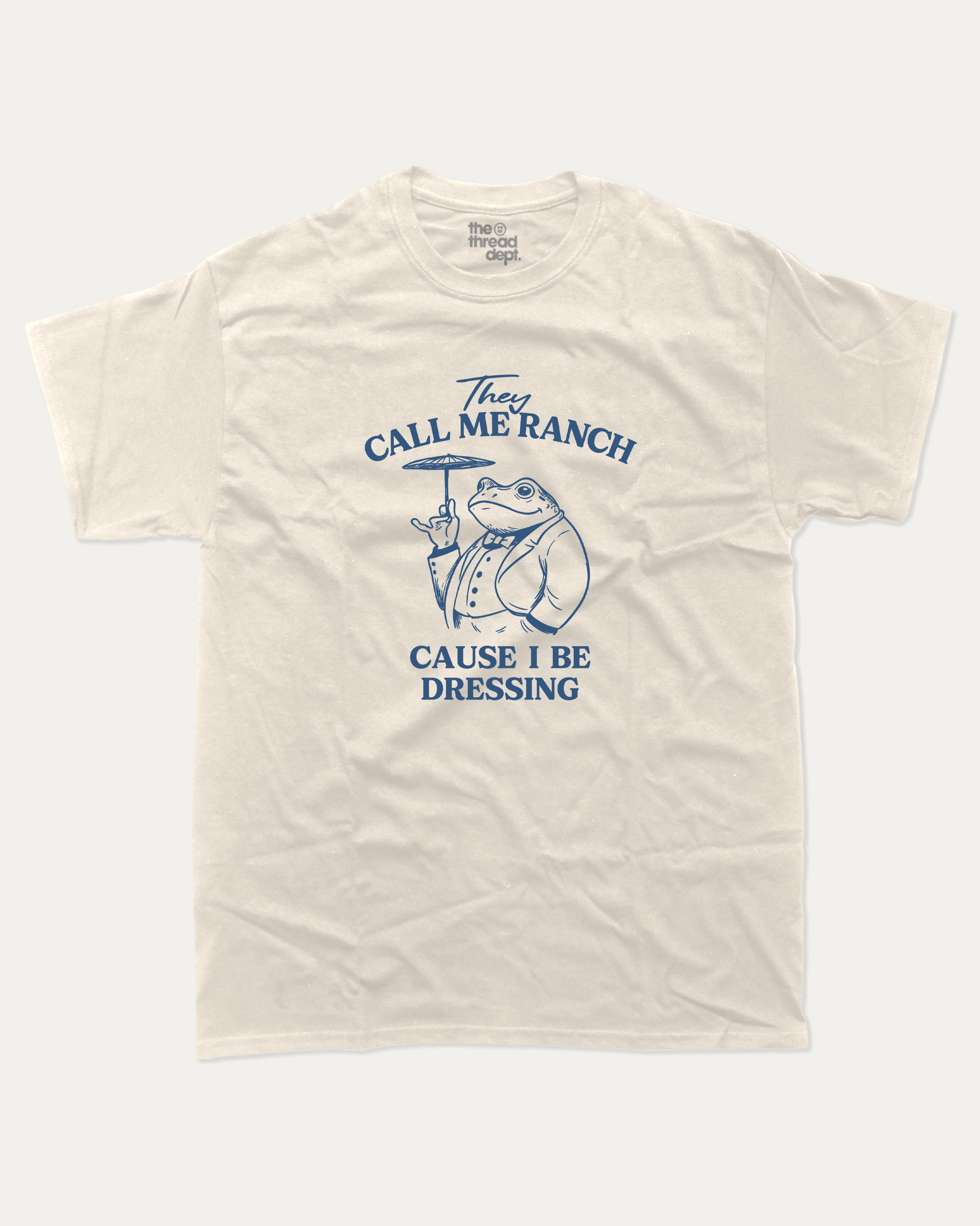They Call Me Ranch Cause I Be Dressing graphic tee with funny frog print, funny and trendy graphic. Perfect for adults and gift-giving. Cream shirt.
