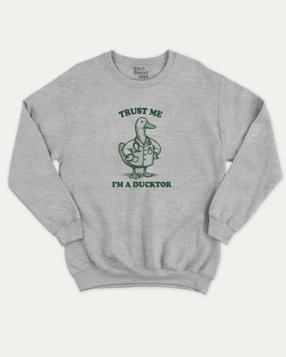 Trust Me I'm A Ducktor pullover sweatshirt, perfect for gifts. A must-have duck graphic pullover, comfy cold-weather wear, bold casual look. Heather Grey sweater
