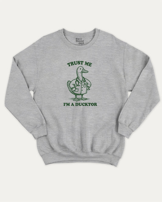 Trust Me I'm A Ducktor pullover sweatshirt, perfect for gifts. A must-have duck graphic pullover, comfy cold-weather wear, bold casual look. Heather Grey sweater