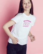Young girl wearing a white t-shirt with 'Big or Small' pink text on a pink background