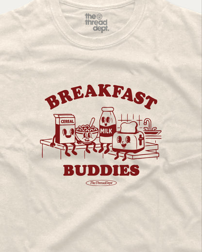 White t-shirt with red 'Breakfast Buddies' graphic featuring cartoon cereal box, milk carton, bowl of cereal, and toaster.