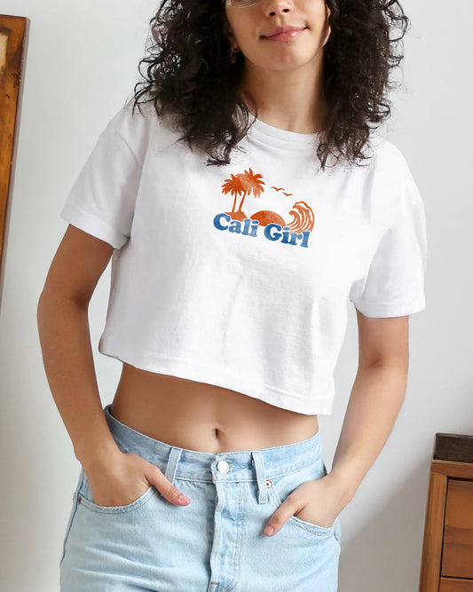 Person wearing a white crop top with 'Cali Girl' graphic design.