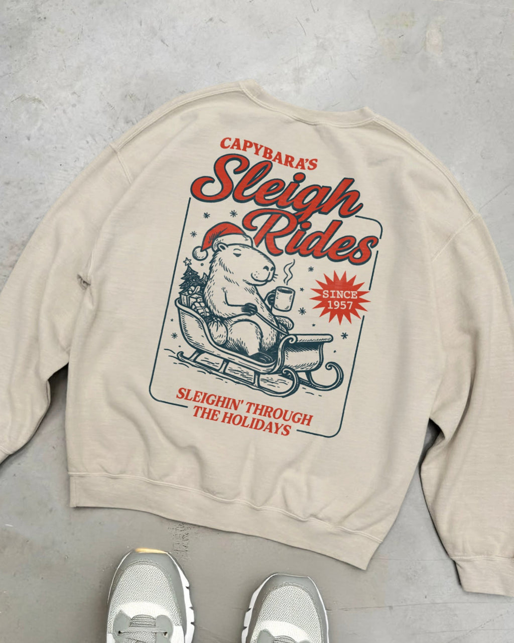 Capybara's Sleigh Rides christmas graphic sweatshirt.
