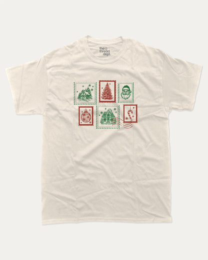 Christmas Stamp graphic tee with bold and humorous print, Perfect Gift for Christmas, Christmas Gift, X-mas Gift for friends, funny and trendy graphic. Perfect for adults and gift-giving. Cream shirt.