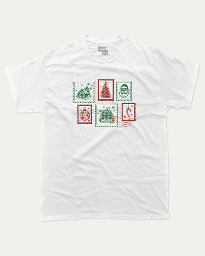 Christmas Stamp graphic tee with bold and humorous print, Perfect Gift for Christmas, Christmas Gift, X-mas Gift for friends, funny and trendy graphic. Perfect for adults and gift-giving. White shirt.
