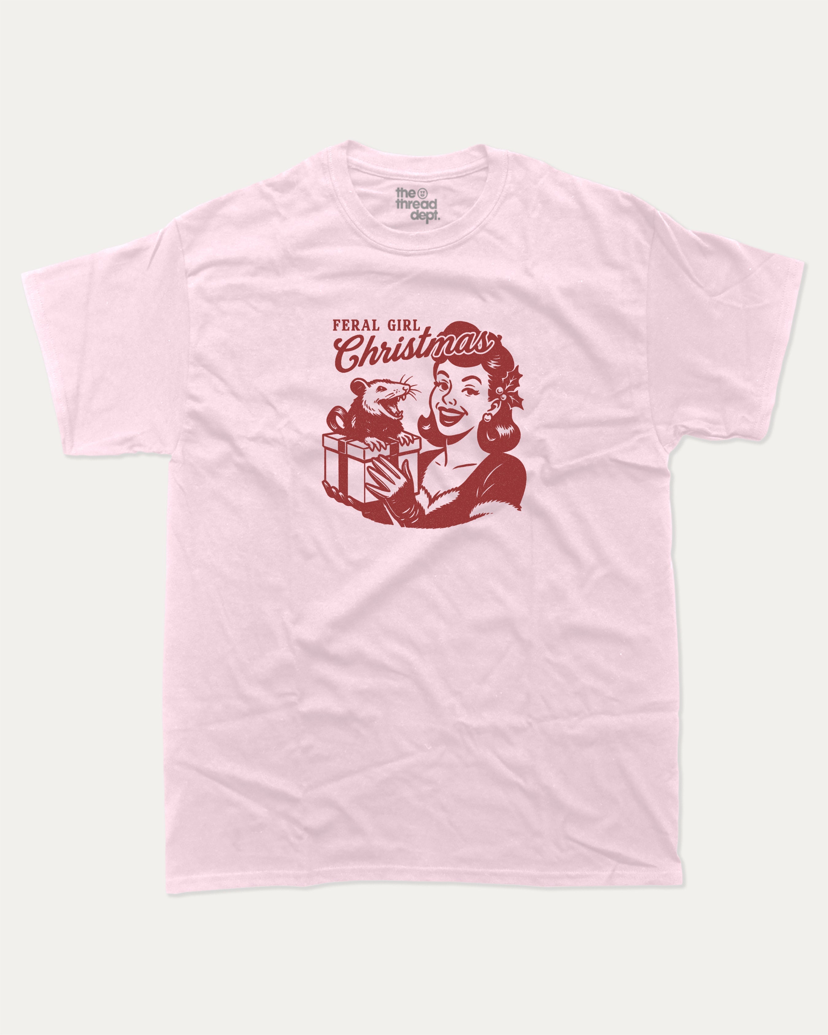 Feral Girl Christmas graphic tee with bold and humorous print, Perfect Gift for Christmas, X Mas Graphic T shirt, X-mas Gift, funny and trendy graphic. Perfect for adults and gift-giving. Pink shirt.