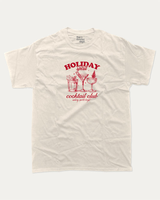 Holiday Spirit Cocktail Club graphic tee with bold and humorous print, funny and trendy graphic. Christmas Gift T shirt, X-mas Graphic T shirt, Drinks lover T shirt,  Perfect for adults and gift-giving. Cream shirt.