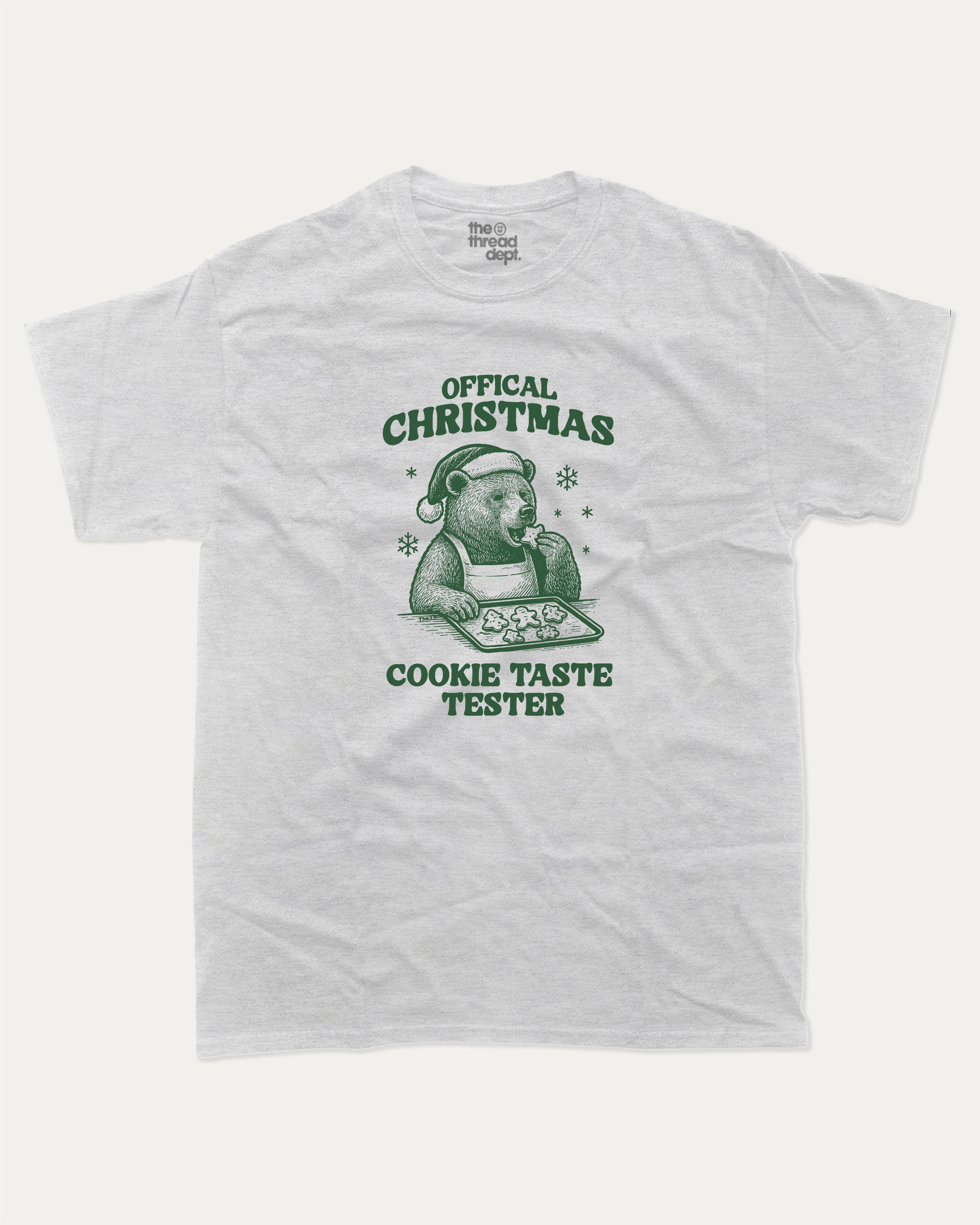 Official Christmas Cookie Taste Tester graphic tee with bold and humorous print, funny and trendy graphic. Perfect Gift for Christmas, X-Mas Gift,  Perfect for adults and gift-giving. Ash Grey shirt.