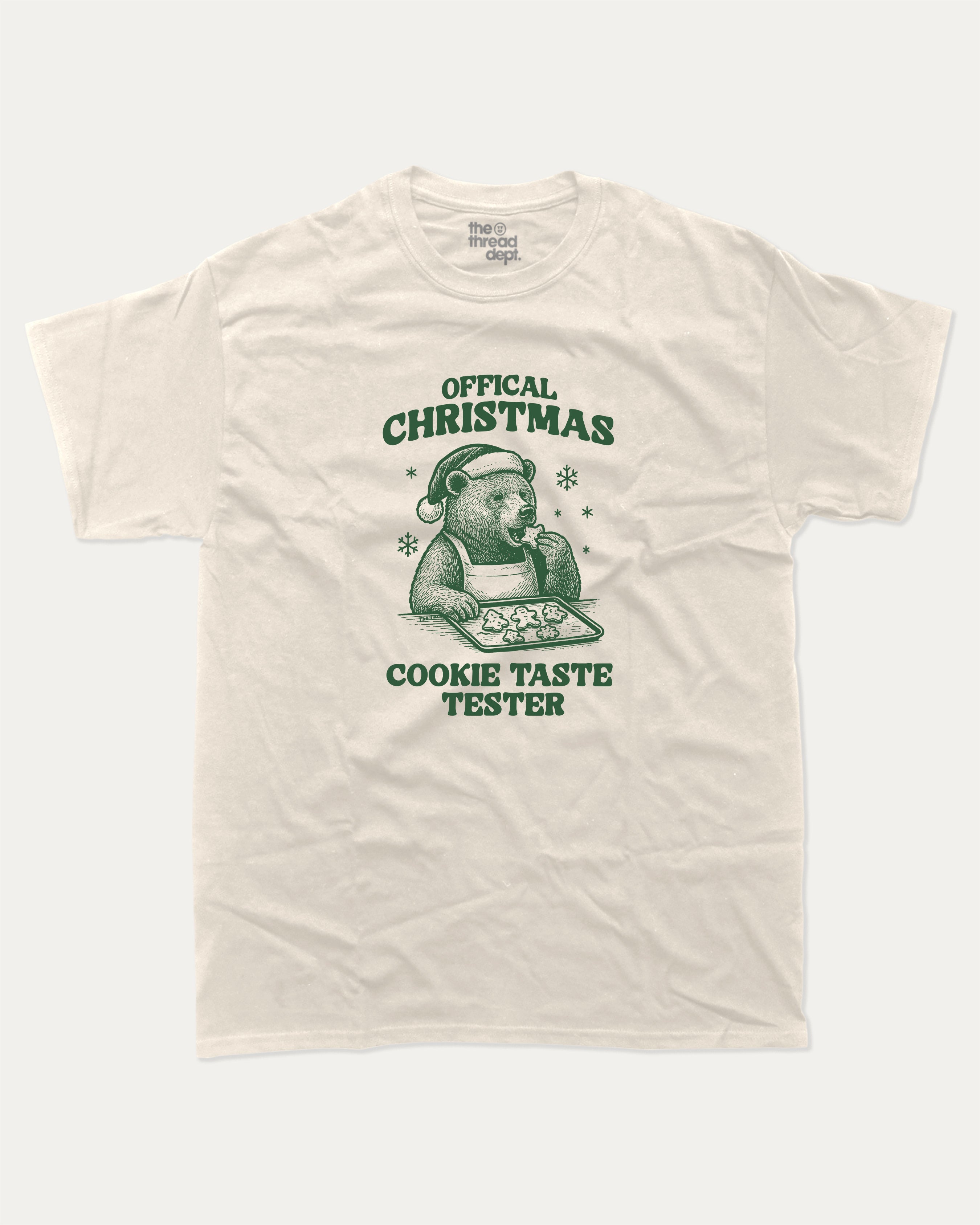 Official Christmas Cookie Taste Tester graphic tee with bold and humorous print, funny and trendy graphic. Perfect Gift for Christmas, X-Mas Gift,  Perfect for adults and gift-giving. Cream shirt.
