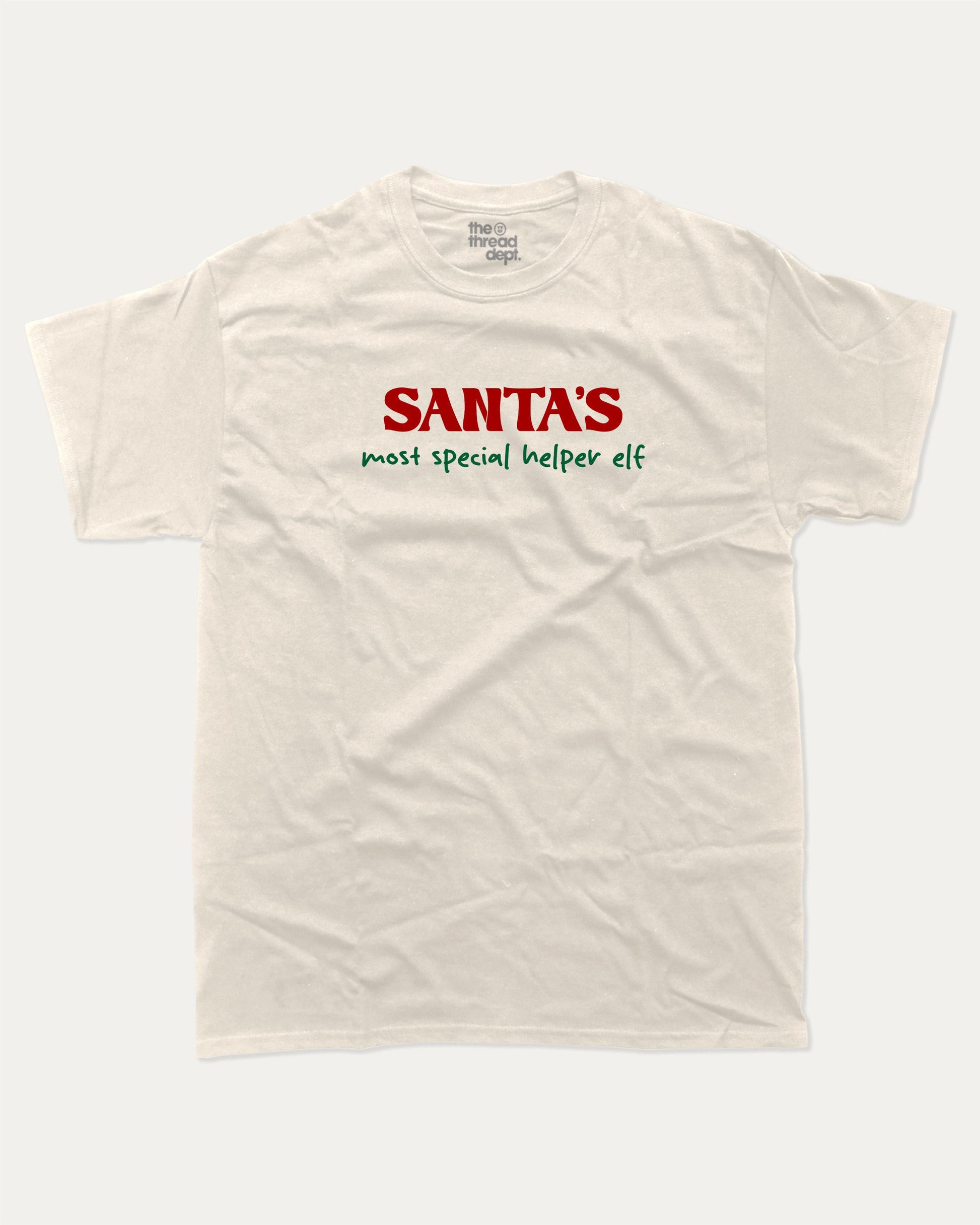 Santa's Most Special Helper graphic tee with bold and humorous print, Perfect Gift for Christmas, Christmas Gift, X-mas Gift for friends, funny and trendy graphic. Perfect for adults and gift-giving. Cream shirt.
