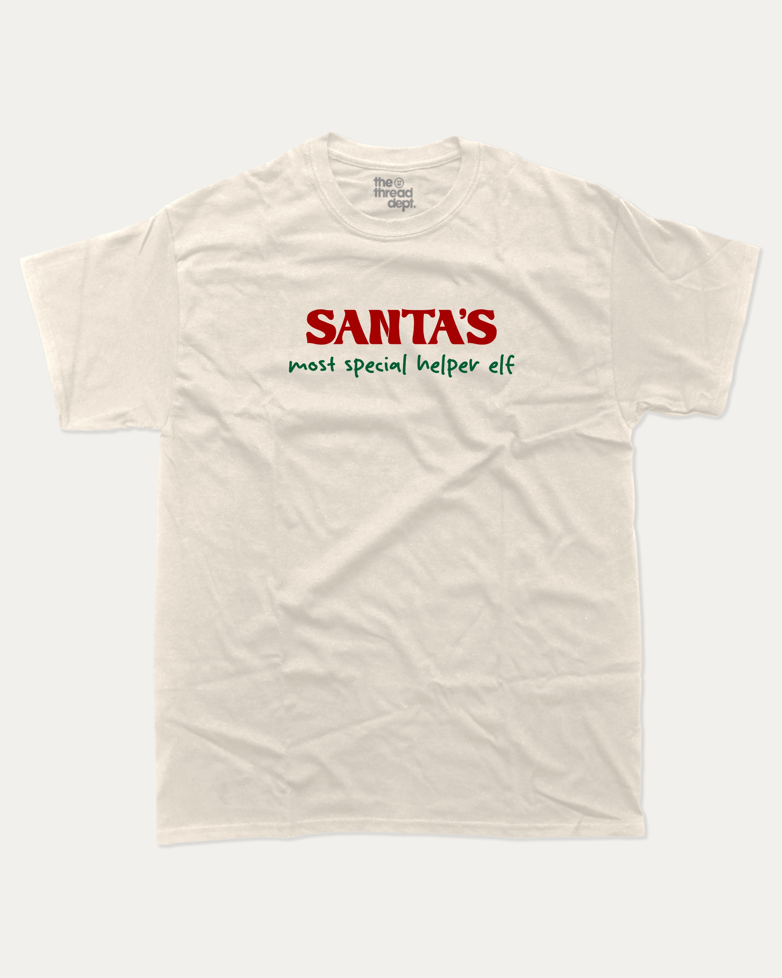 Santa's Most Special Helper graphic tee with bold and humorous print, Perfect Gift for Christmas, Christmas Gift, X-mas Gift for friends, funny and trendy graphic. Perfect for adults and gift-giving. Cream shirt.