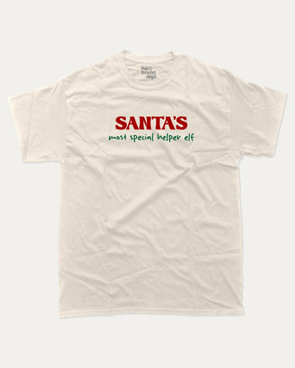 Santa's Most Special Helper graphic tee with bold and humorous print, Perfect Gift for Christmas, Christmas Gift, X-mas Gift for friends, funny and trendy graphic. Perfect for adults and gift-giving. Cream shirt.