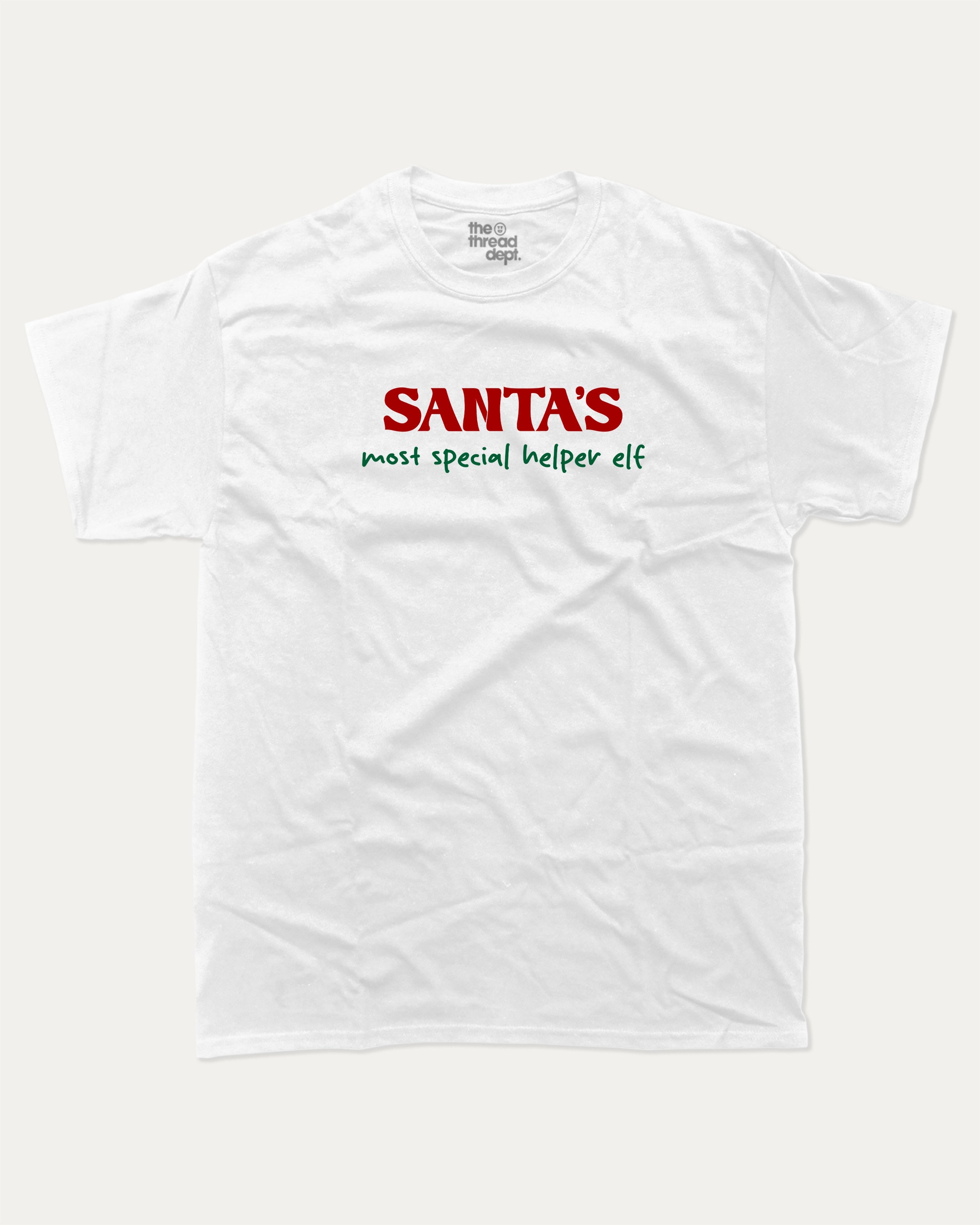 Santa's Most Special Helper graphic tee with bold and humorous print, Perfect Gift for Christmas, Christmas Gift, X-mas Gift for friends, funny and trendy graphic. Perfect for adults and gift-giving. White shirt.