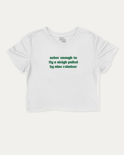 Sober Enough To Fly A Sleigh Pulled By Nine Reindeer graphic crop tee with funny and trendy slogan print, Perfect Gift for Christmas, X-mas Gift,  perfect for women’s casual looks or layering. White crop t-shirt.